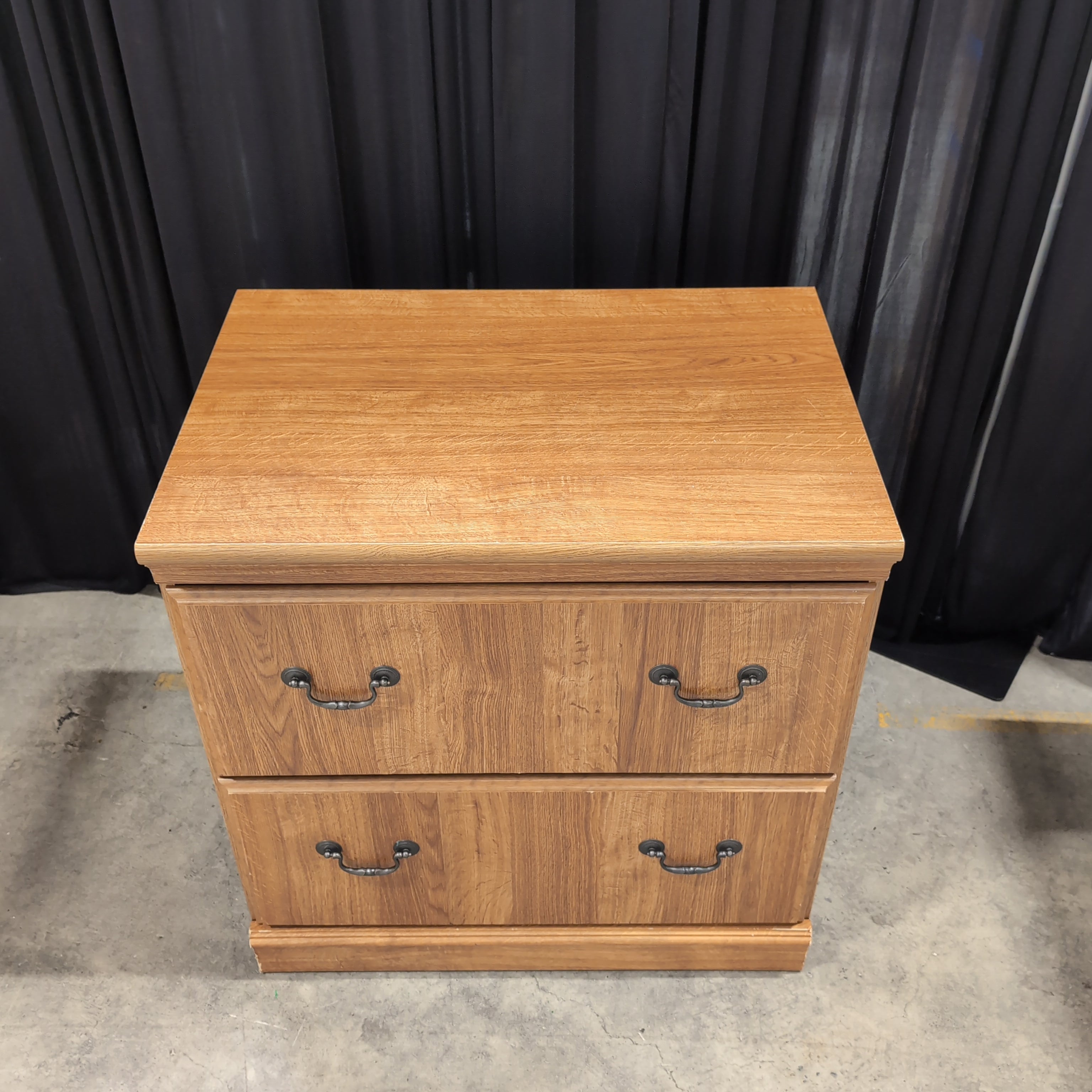 Brown Wood Three-Drawer Dresser with Dark Metal Pulls