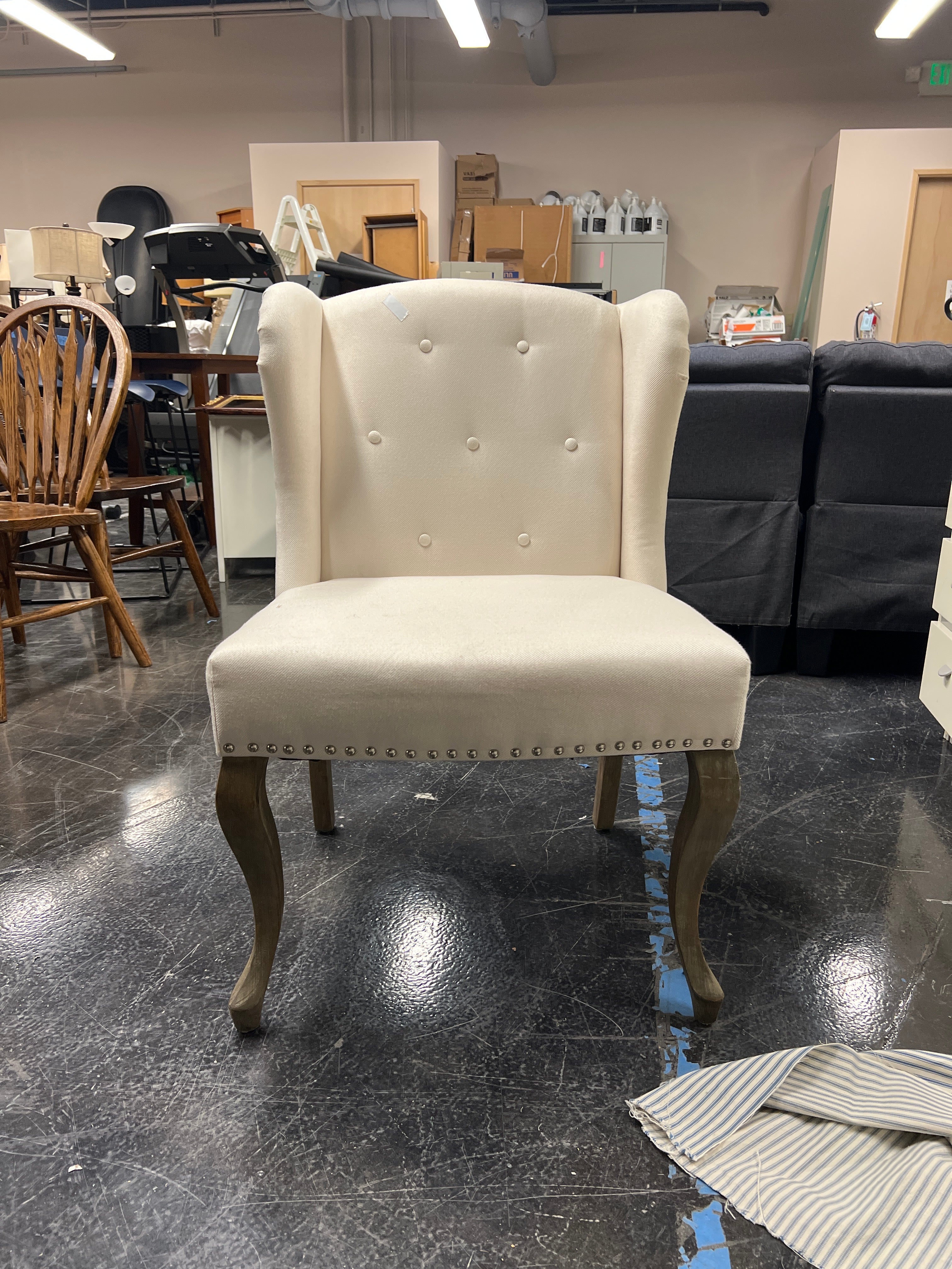Cream-Colored Wingback Chair with Button Tufting