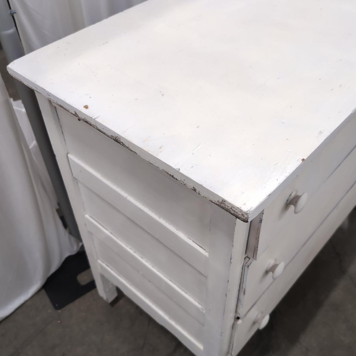 White Wood Three-Drawer Dresser with Round Knobs