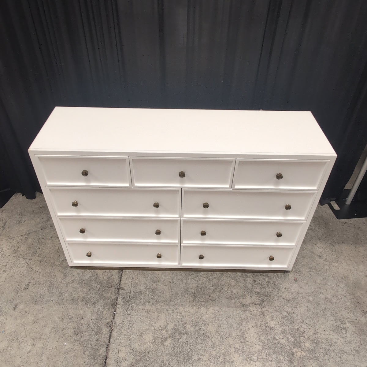 Clean-Lined White Nine-Drawer Dresser with Brass Knobs