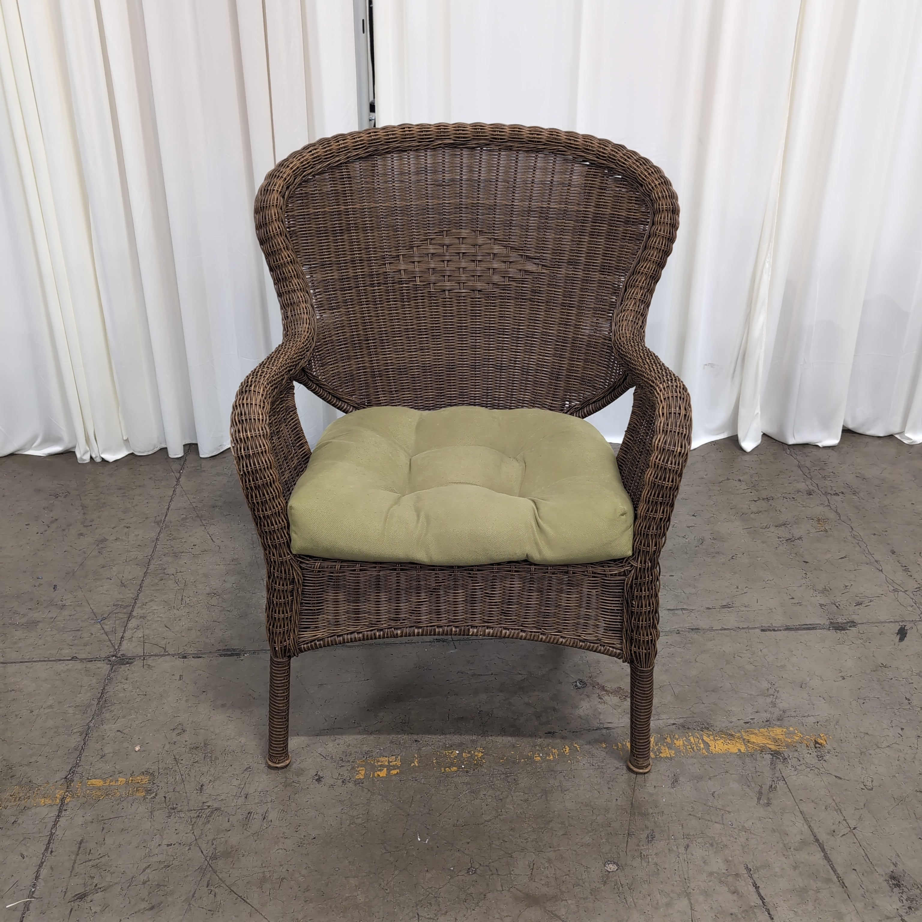 Brown Wicker Accent Chair with Green Cushion