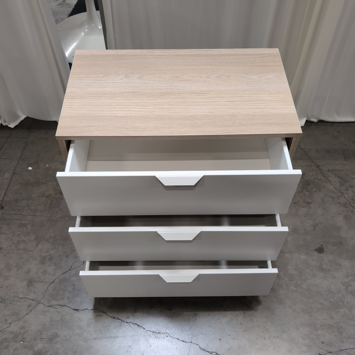 Light Wood Three-Drawer Nightstand with Recessed Pulls
