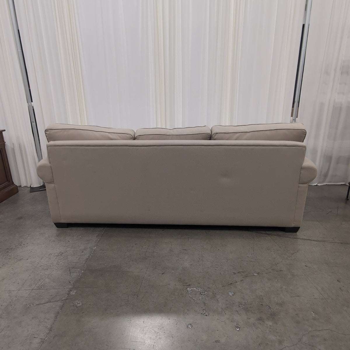 Tan Fabric Three-Cushion Couch with Rolled Arms
