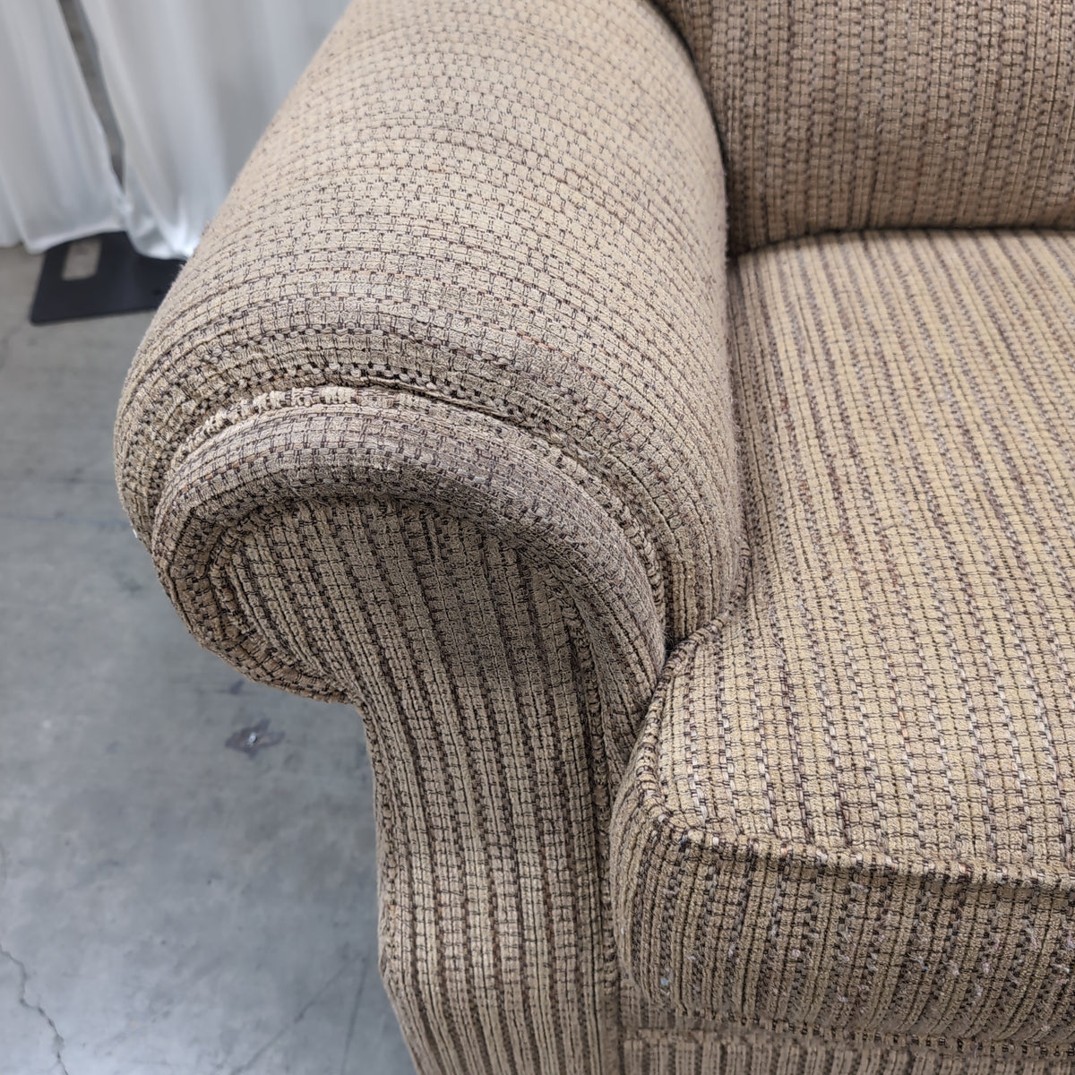Tan Textured Fabric Three-Cushion Couch with Rolled Arms