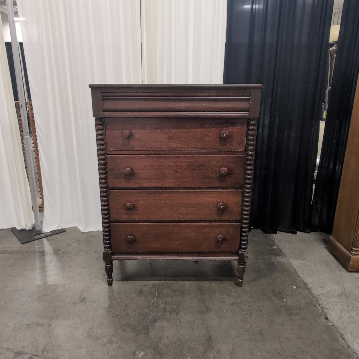 Dark Wood Four-Drawer Dresser with Turned Columns
