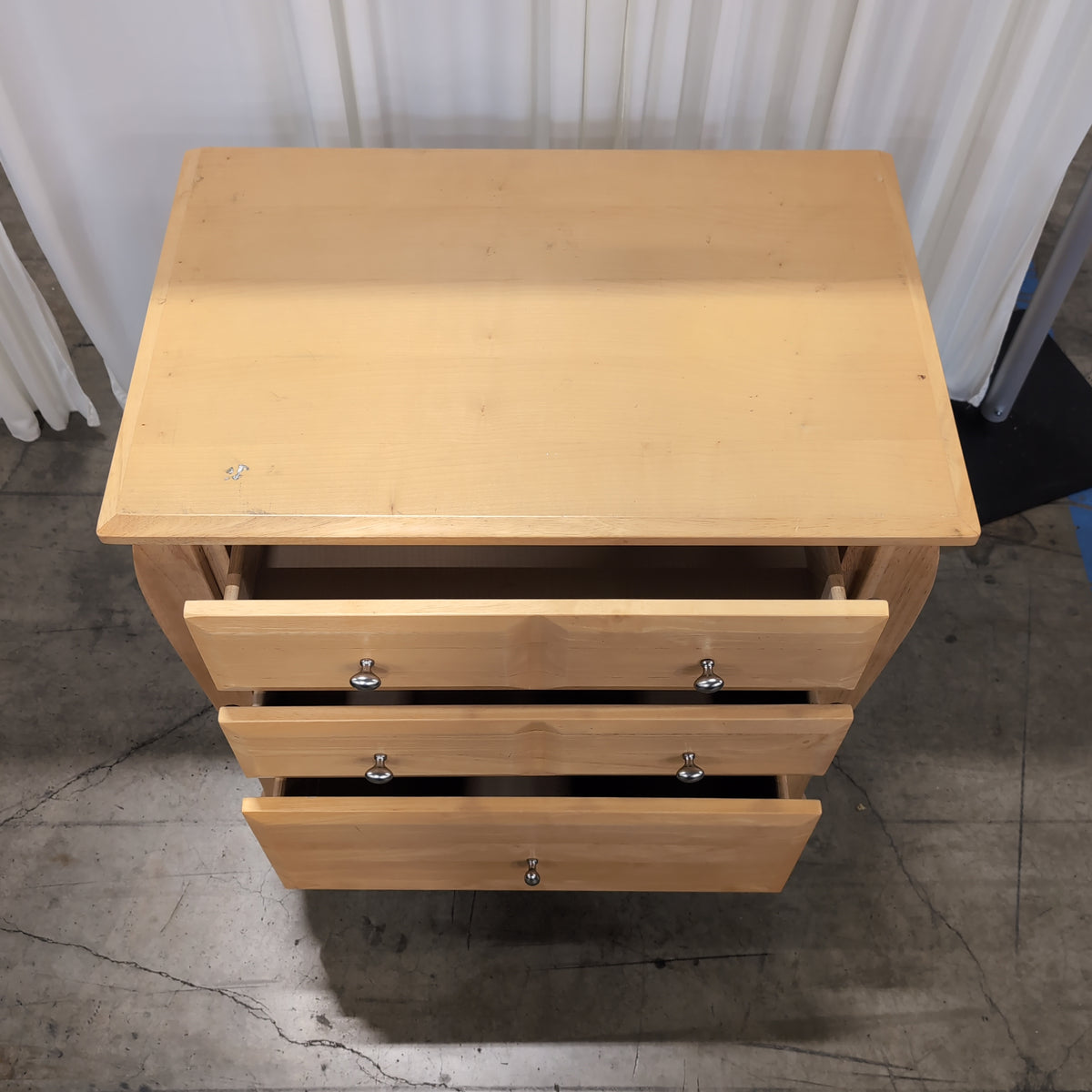 Light Wood Three-Drawer Nightstand with Curved Sides