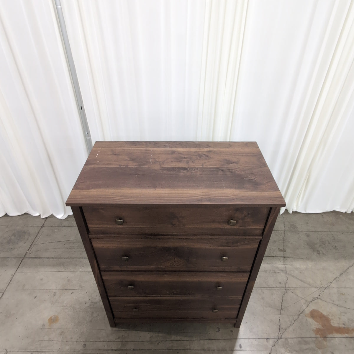 Dark Wood Four-Drawer Dresser with Metal Pulls