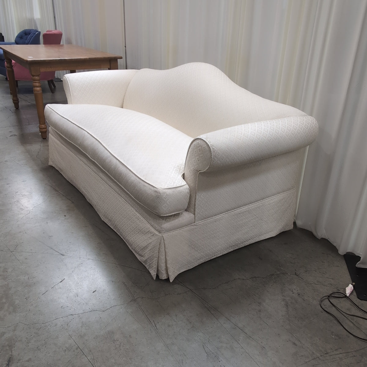 Cream Patterned Fabric Loveseat with Rolled Arms