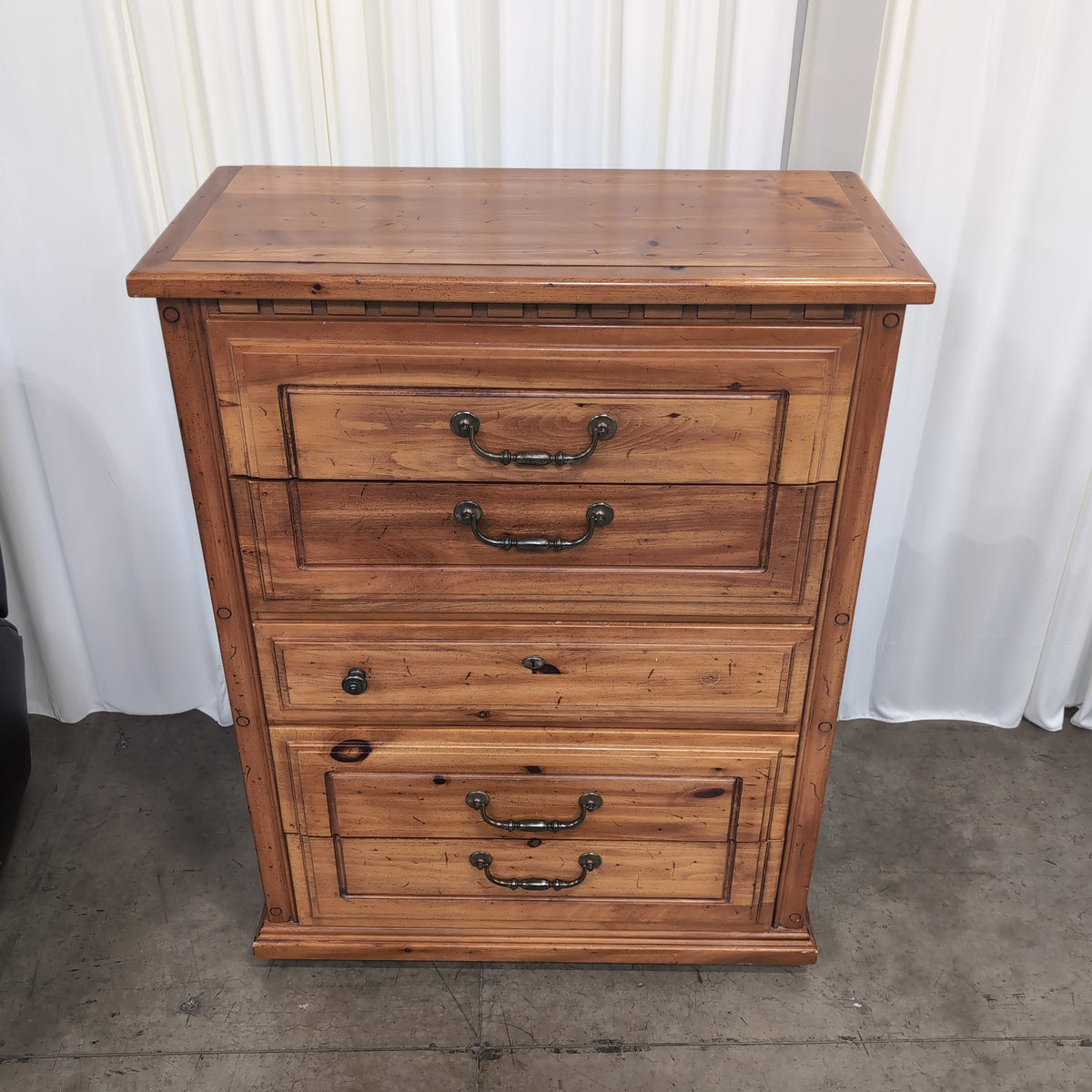 Honey-Toned Wood Four-Drawer Dresser with Decorative Molding