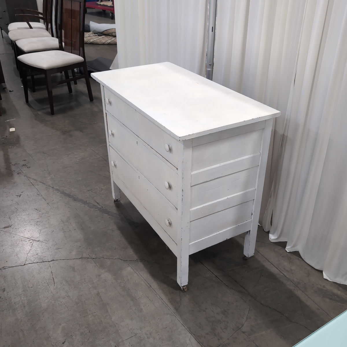 White Wood Three-Drawer Dresser with Round Knobs