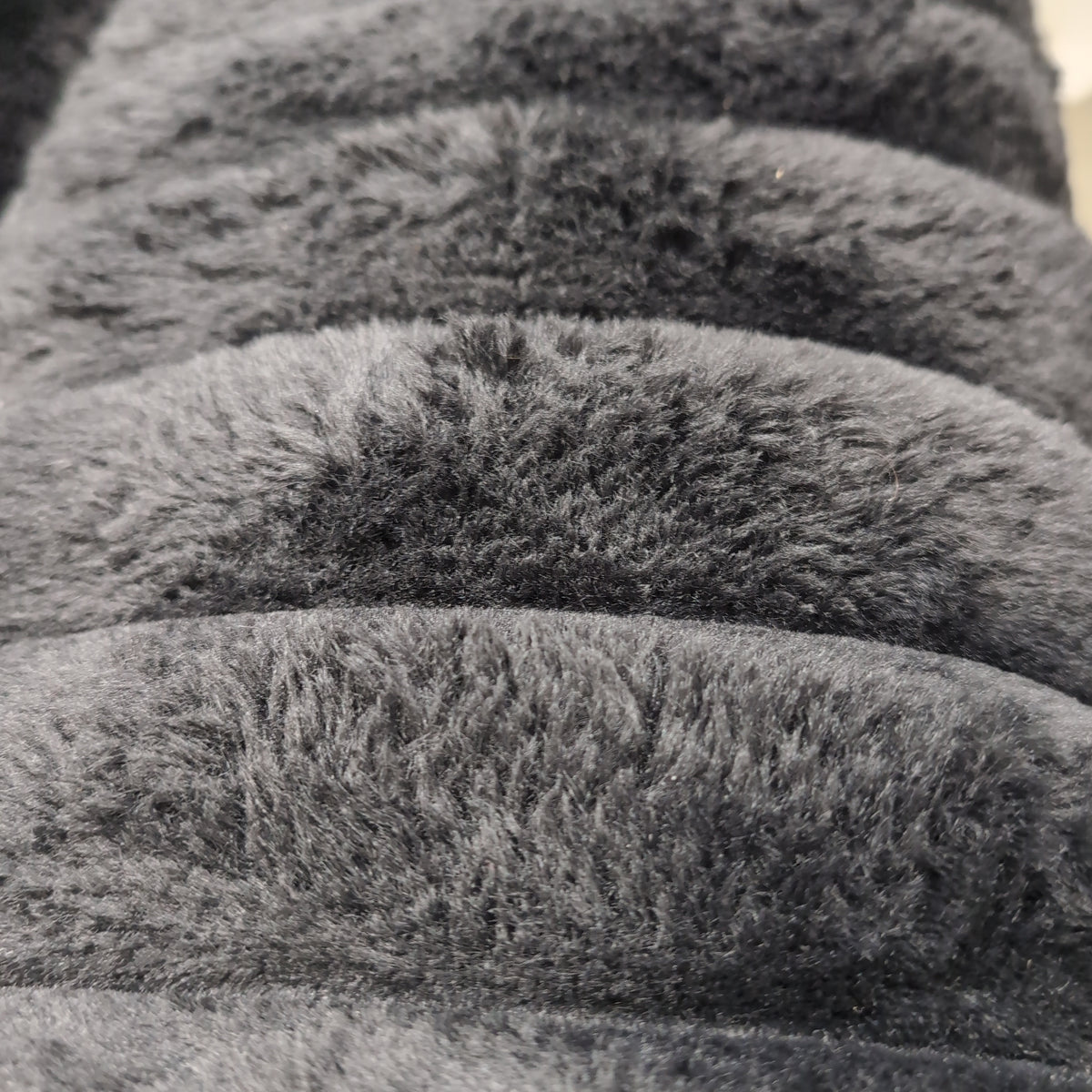 Black Ribbed Plush Sectional Couch with Geometric Throw Pillows