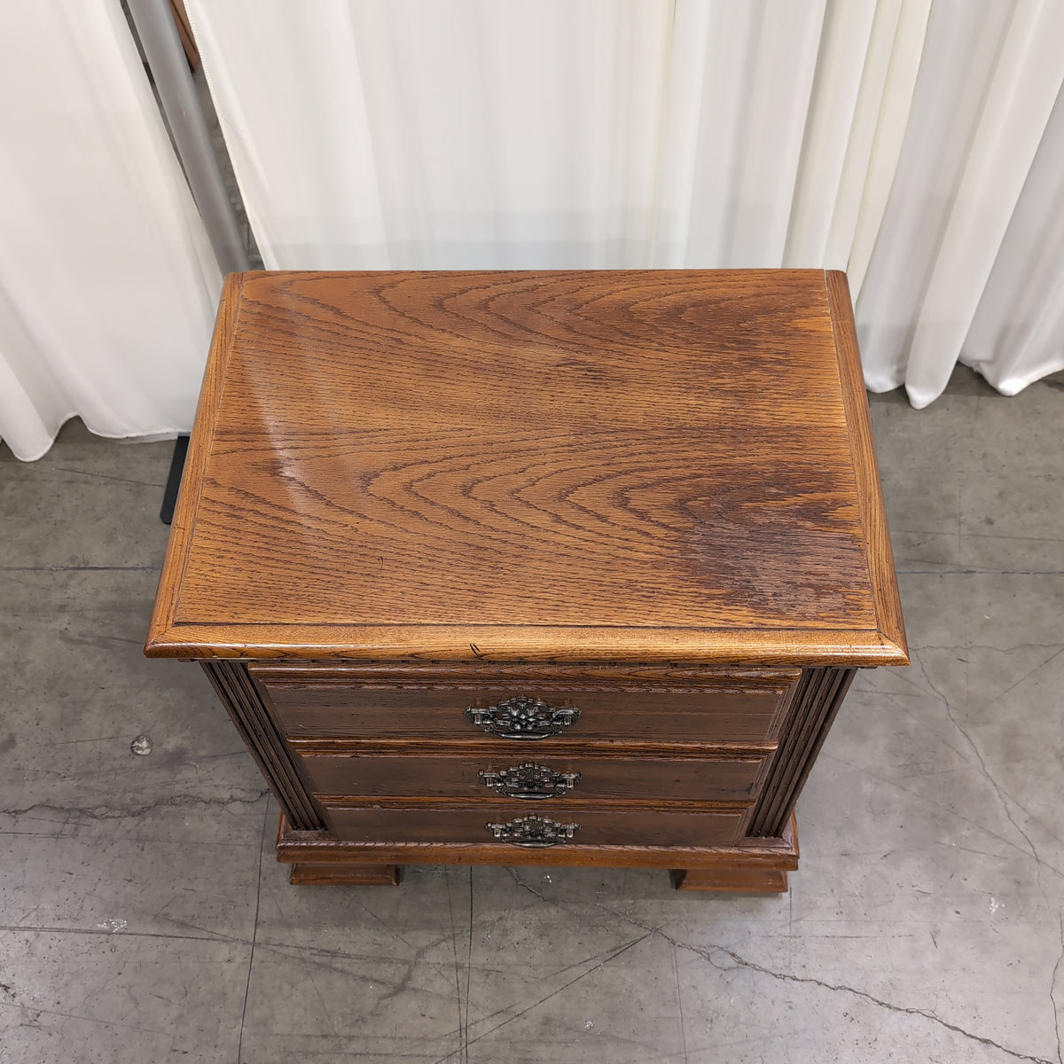 Traditional Brown Wood Three-Drawer Nightstand with Ornate Hardware