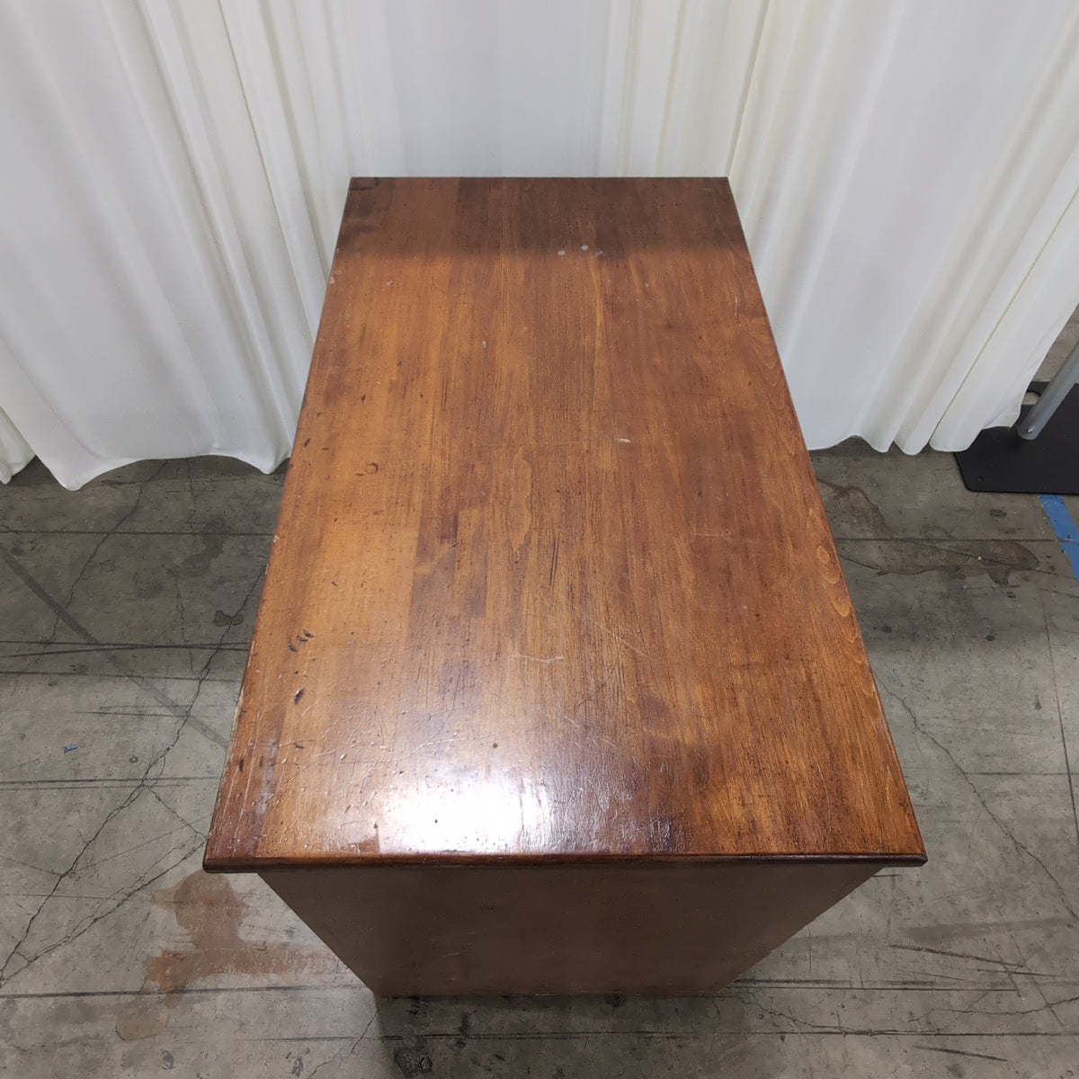 Brown Wood Four-Drawer Desk with Round Knobs