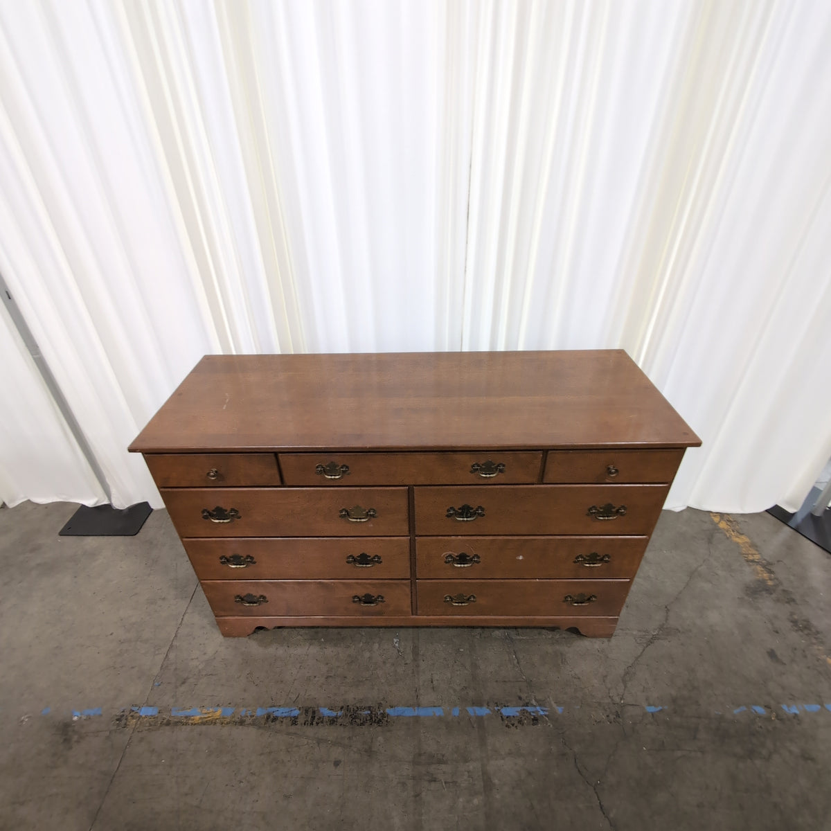Brown Wood Nine-Drawer Dresser with Ornate Hardware