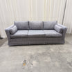 Textured Gray Three-Cushion Couch with Skirted Base
