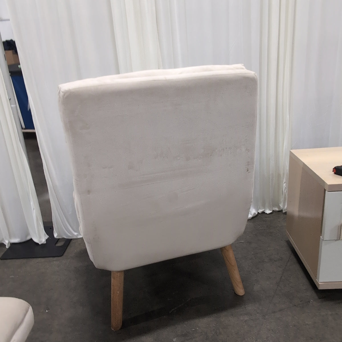 Cream Upholstered Four-Cushion Ottoman with Tapered Legs