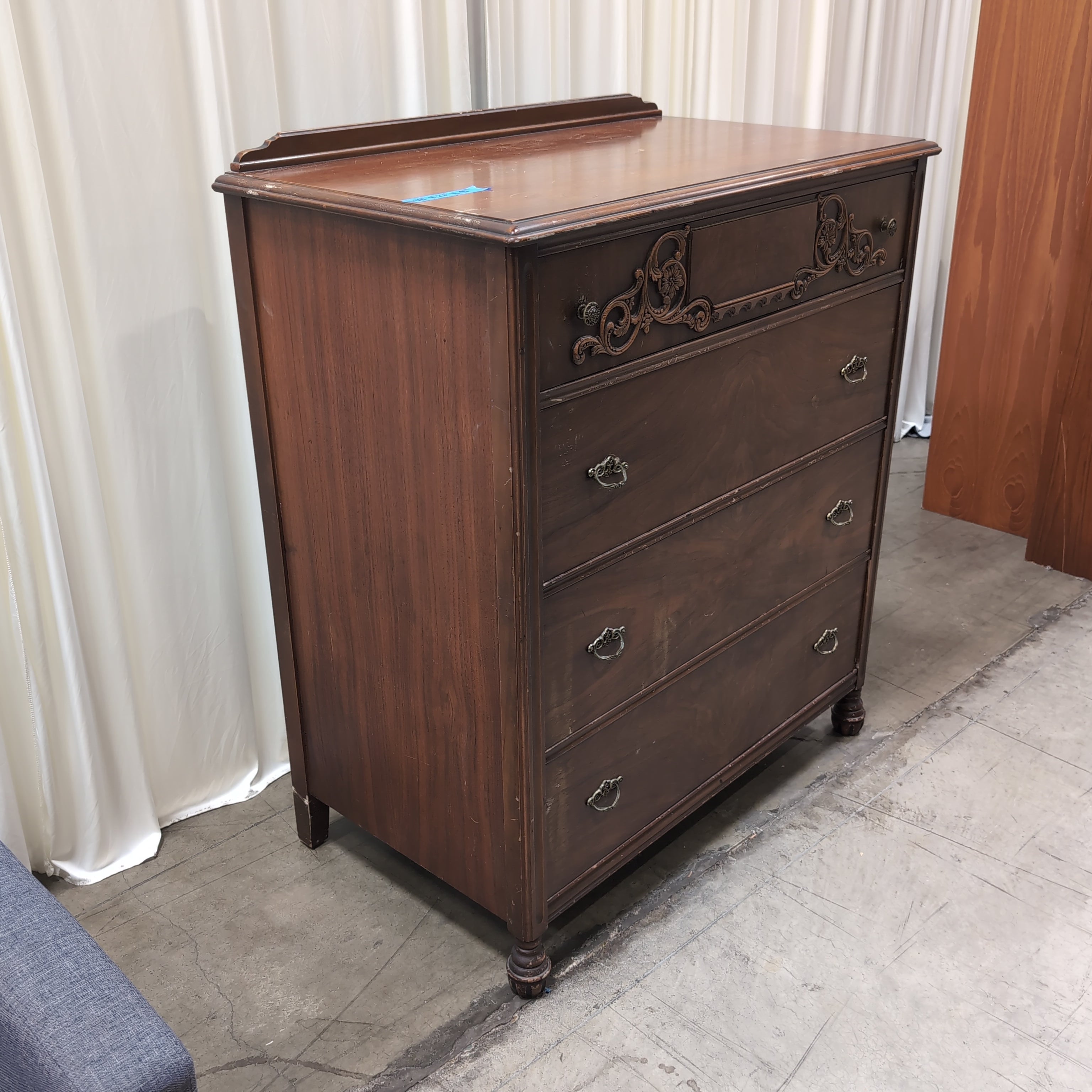 Vintage Dark Wood Four-Drawer Dresser with Ornate Carving