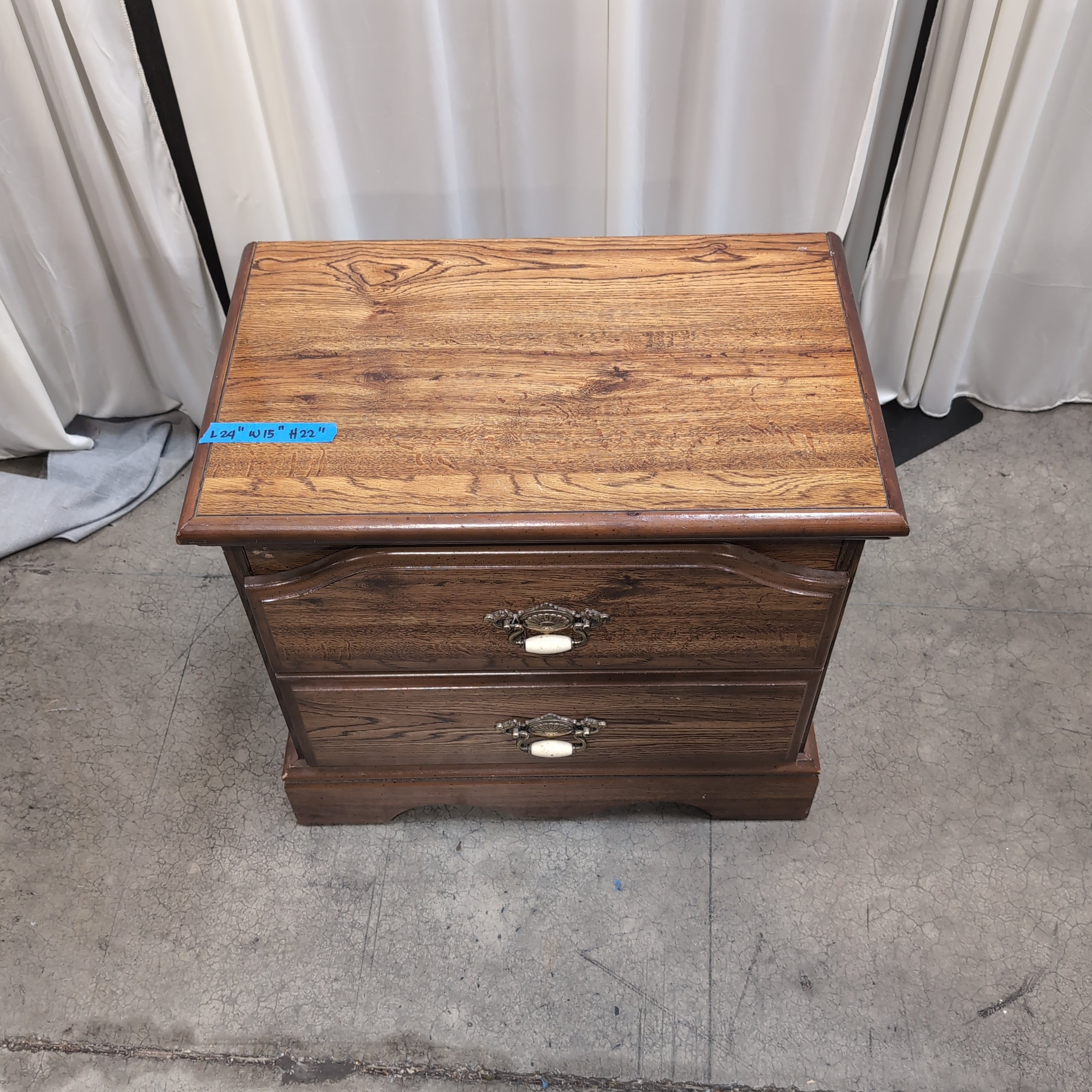 Brown Two-Drawer Wood Nightstand with Ornate Pulls