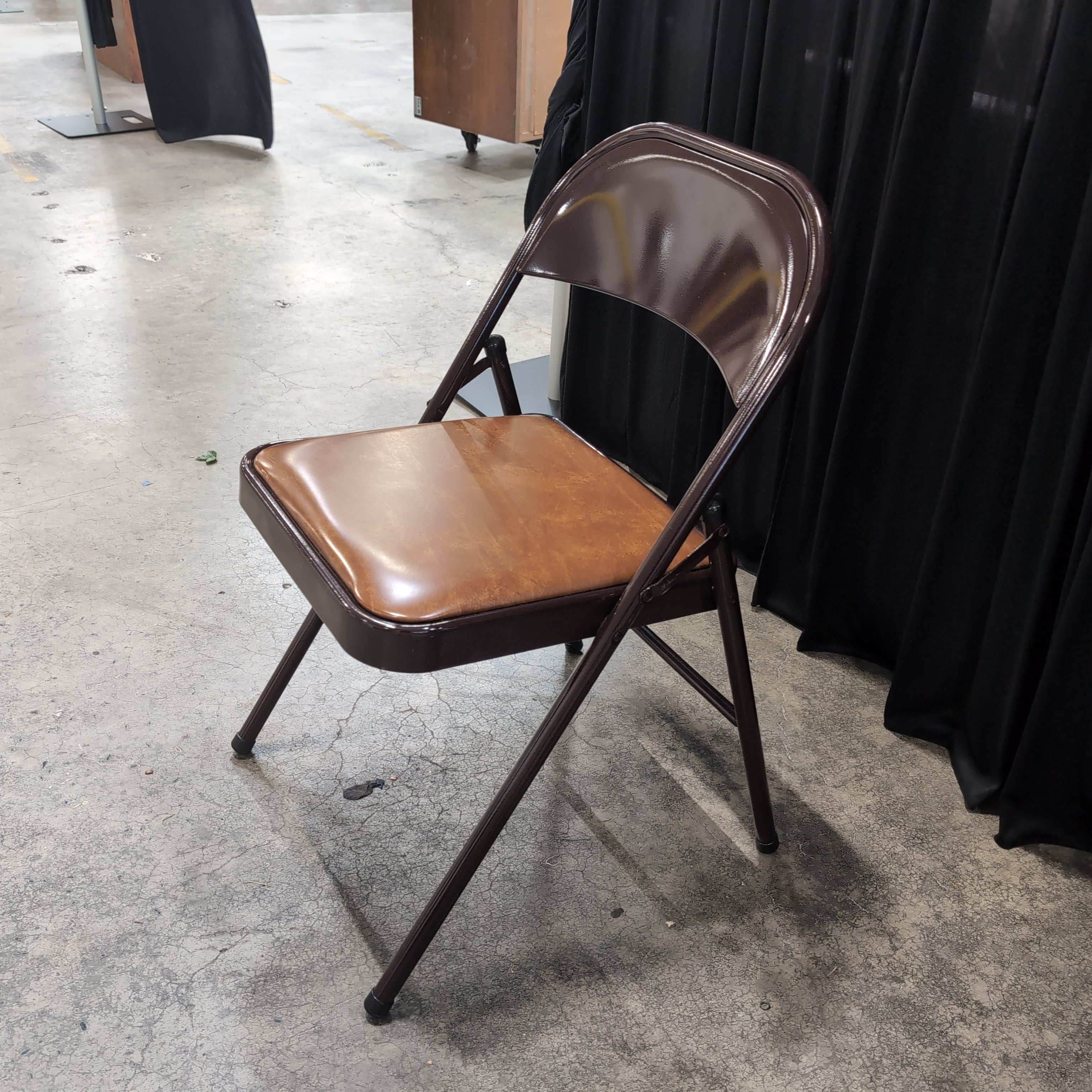 Brown Metal Folding Chair with Tan Upholstered Seat