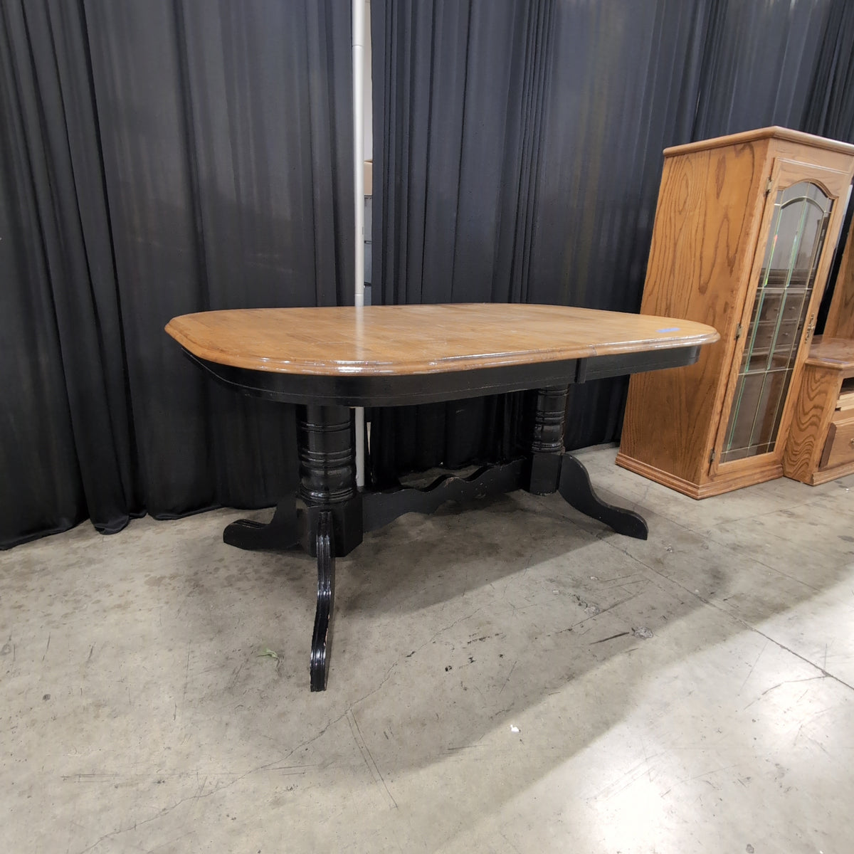 Light Wood Oval Dining Table with Dark Pedestal Base