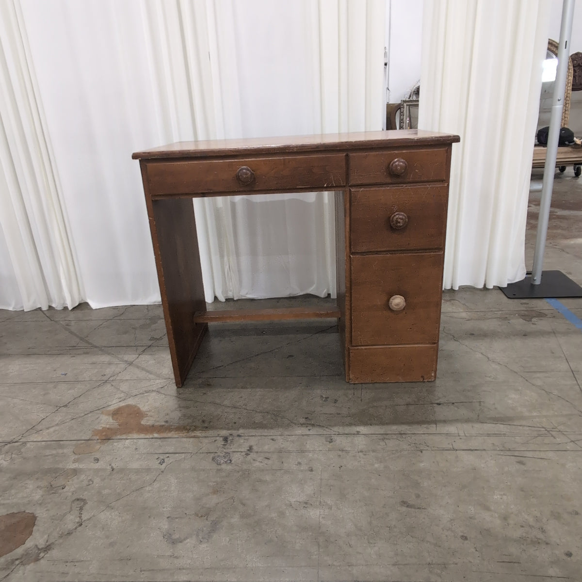 Brown Wood Four-Drawer Desk with Round Knobs
