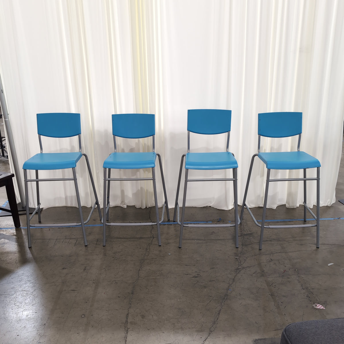 Set of Four Stackable Blue Plastic Chairs