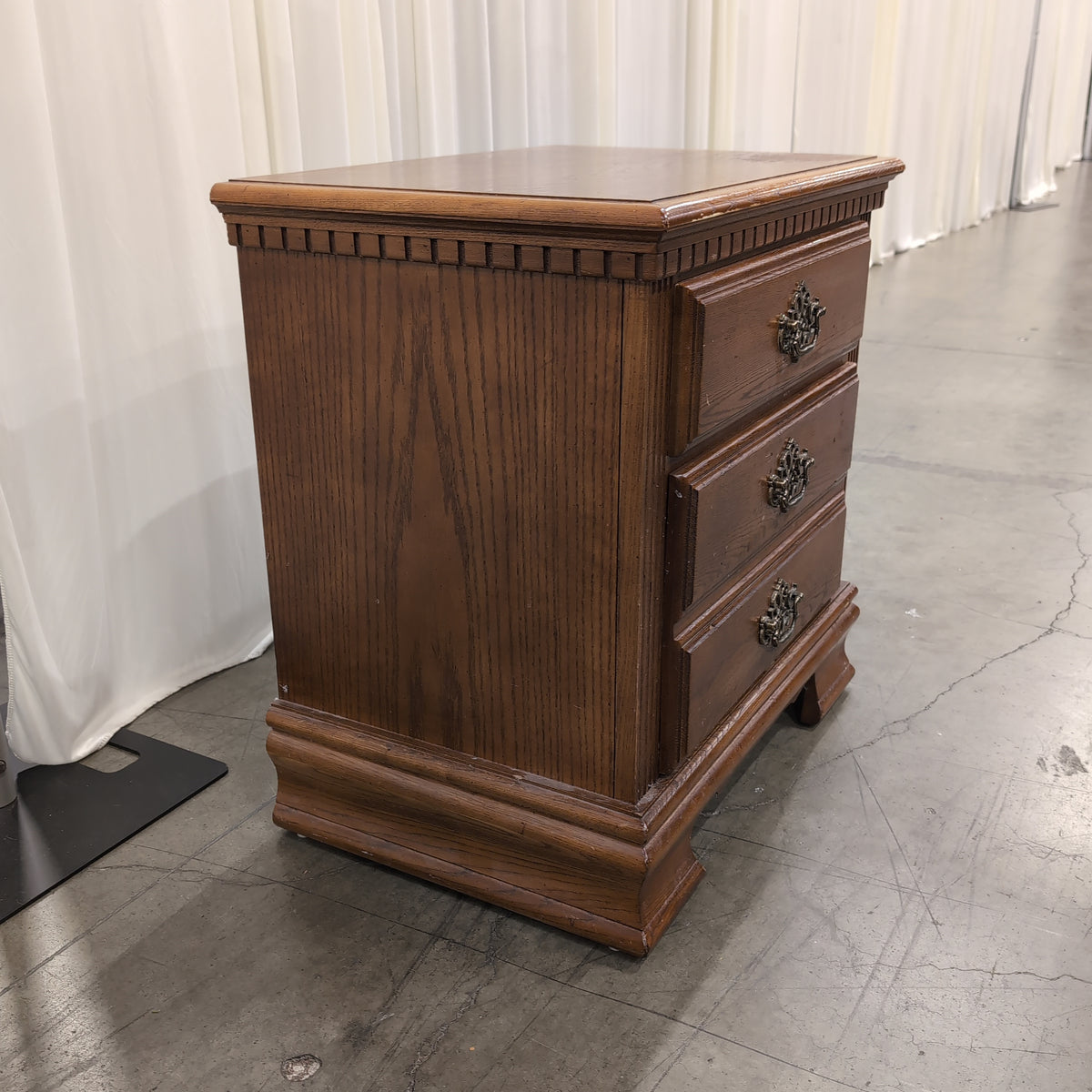 Traditional Brown Wood Three-Drawer Nightstand with Ornate Hardware