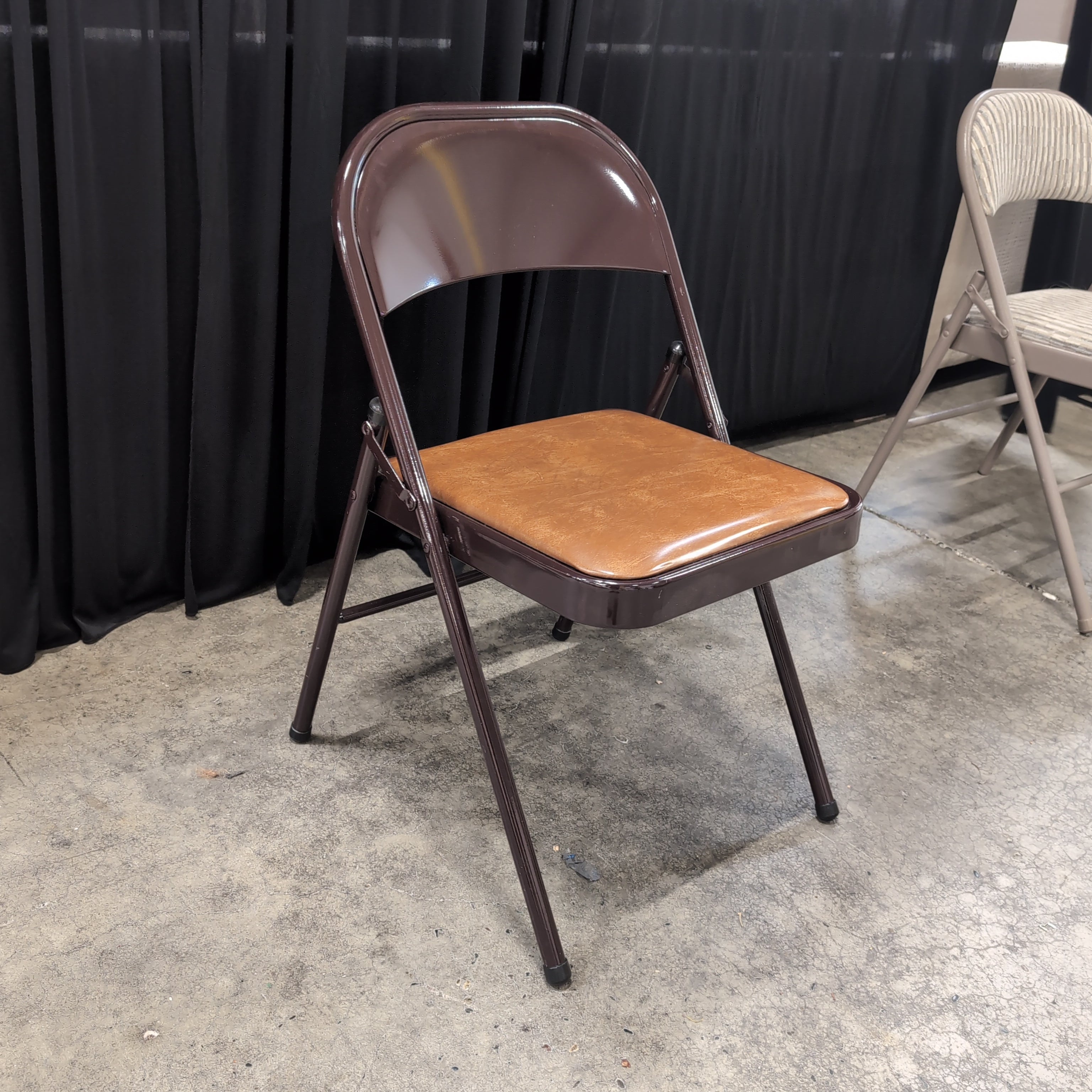 Brown Metal Folding Chair with Tan Upholstered Seat