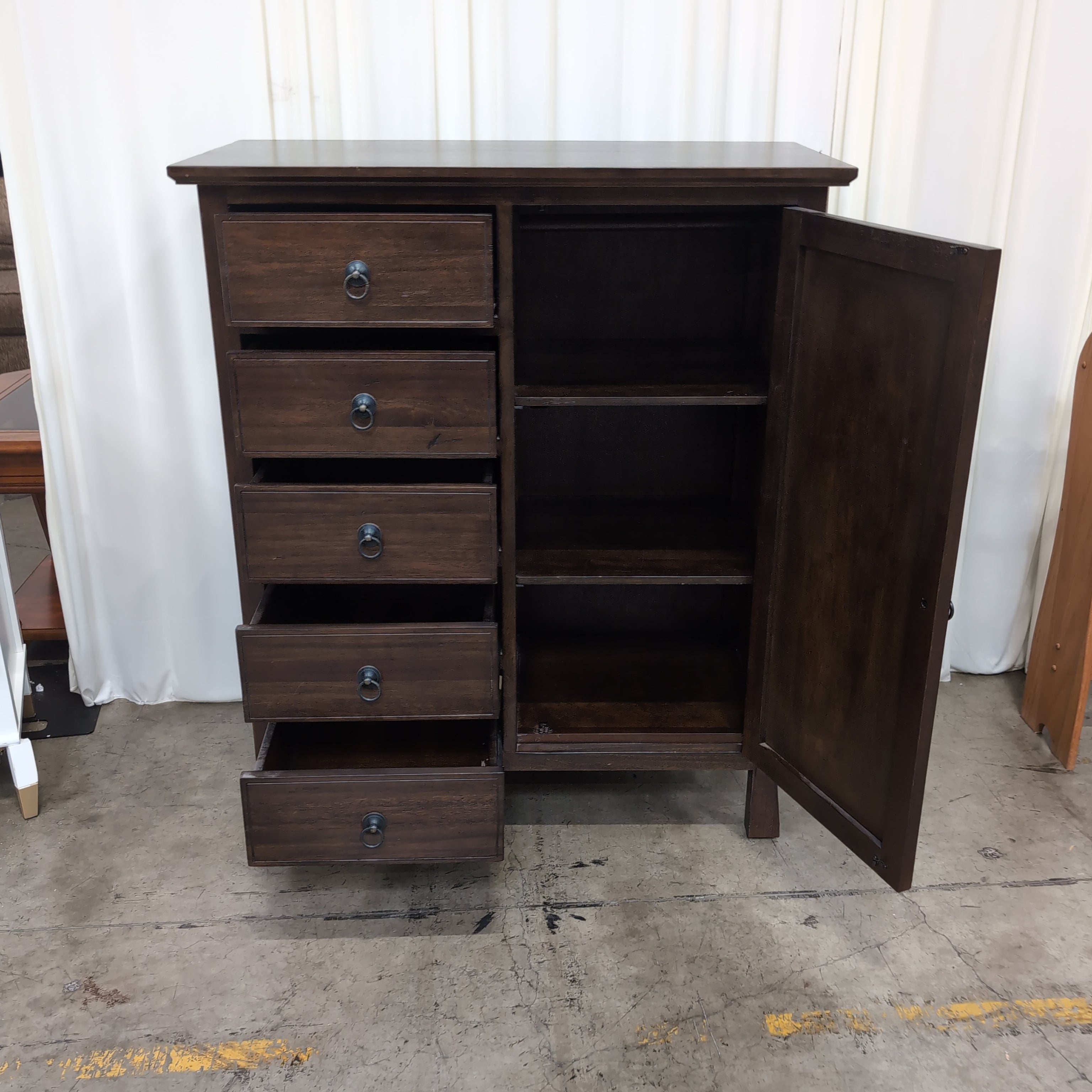 Dark Wood Five-Drawer Dresser with Ornate Panel