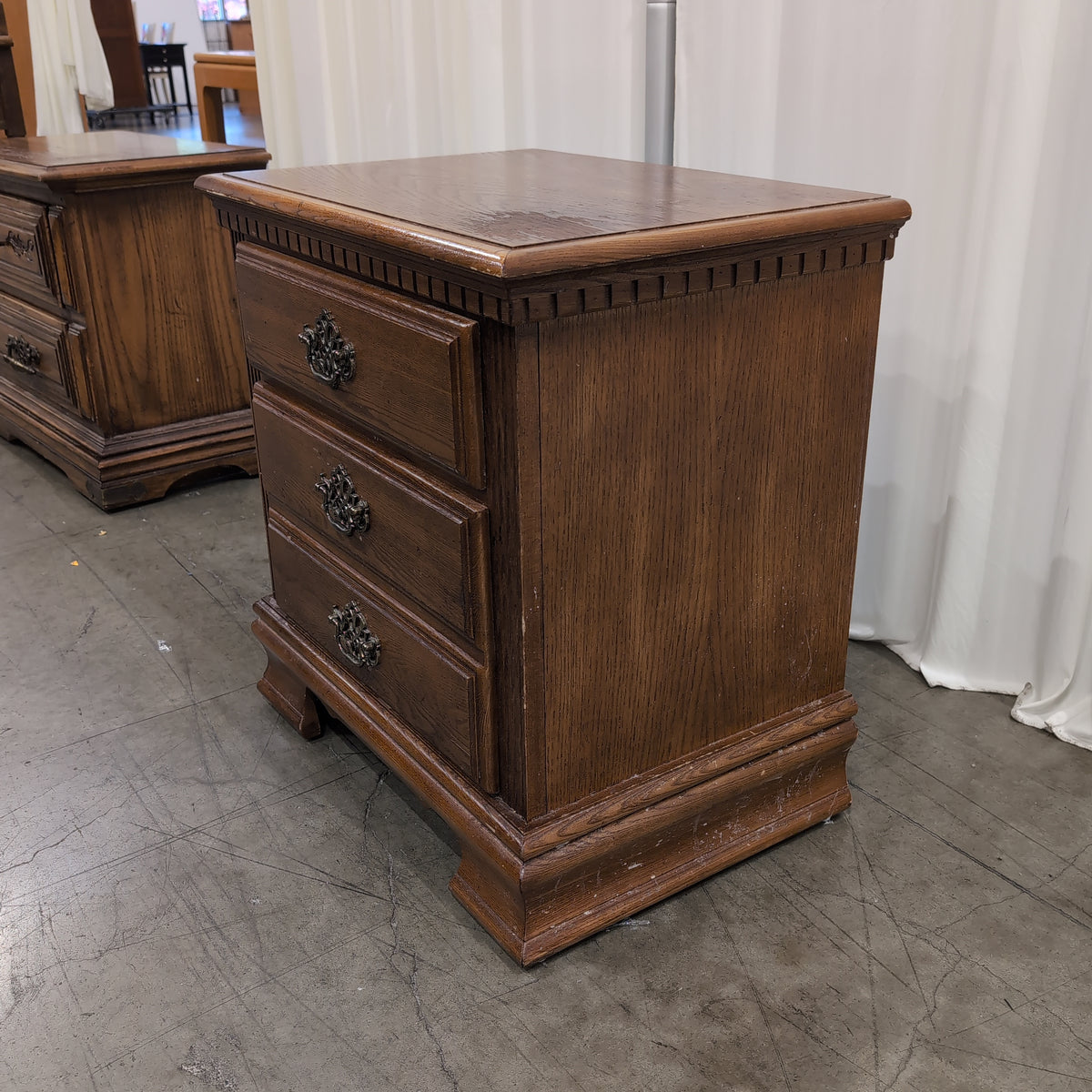 Traditional Brown Wood Three-Drawer Nightstand with Ornate Hardware