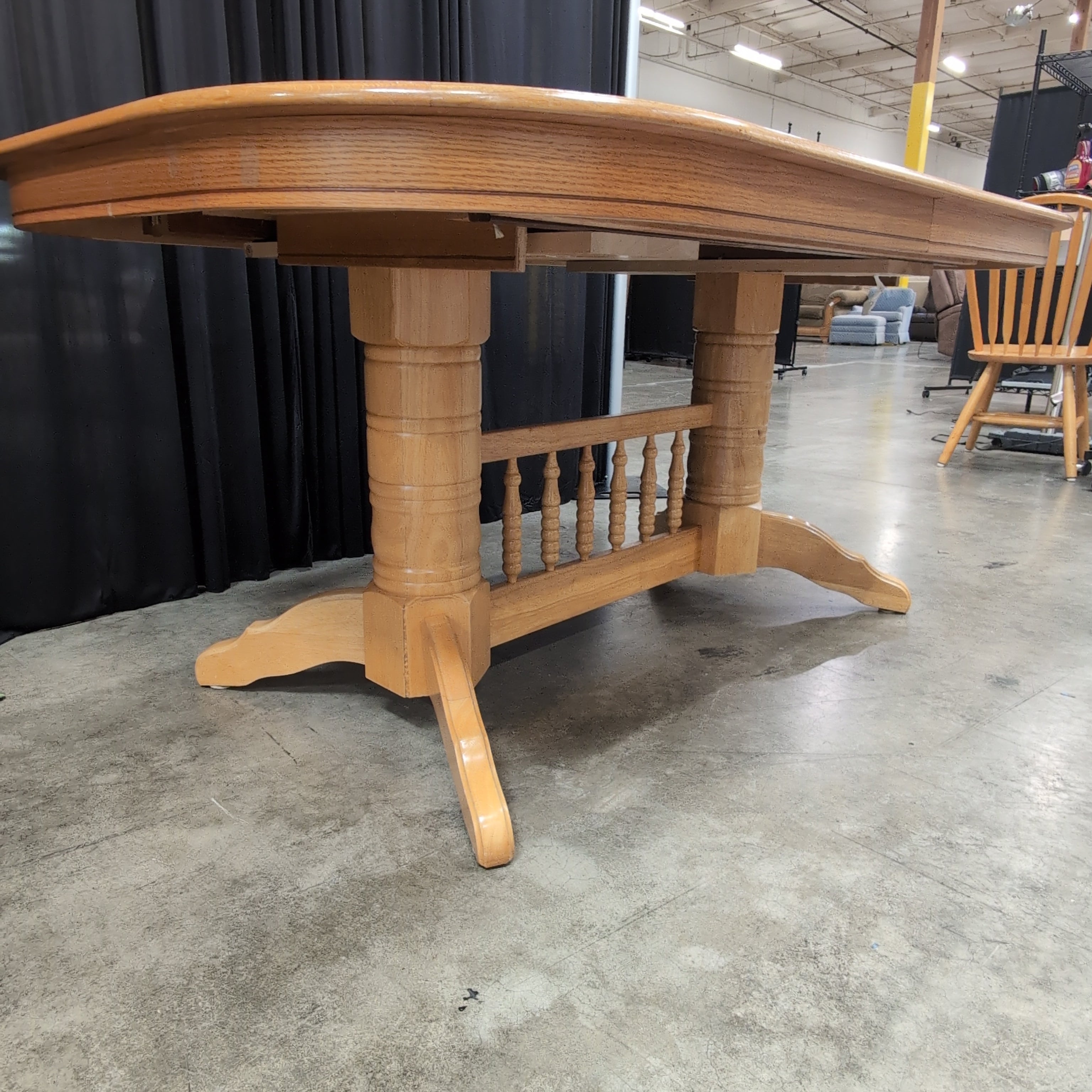 Light Wood Oval Top Dining Table with Spindle Back Chairs