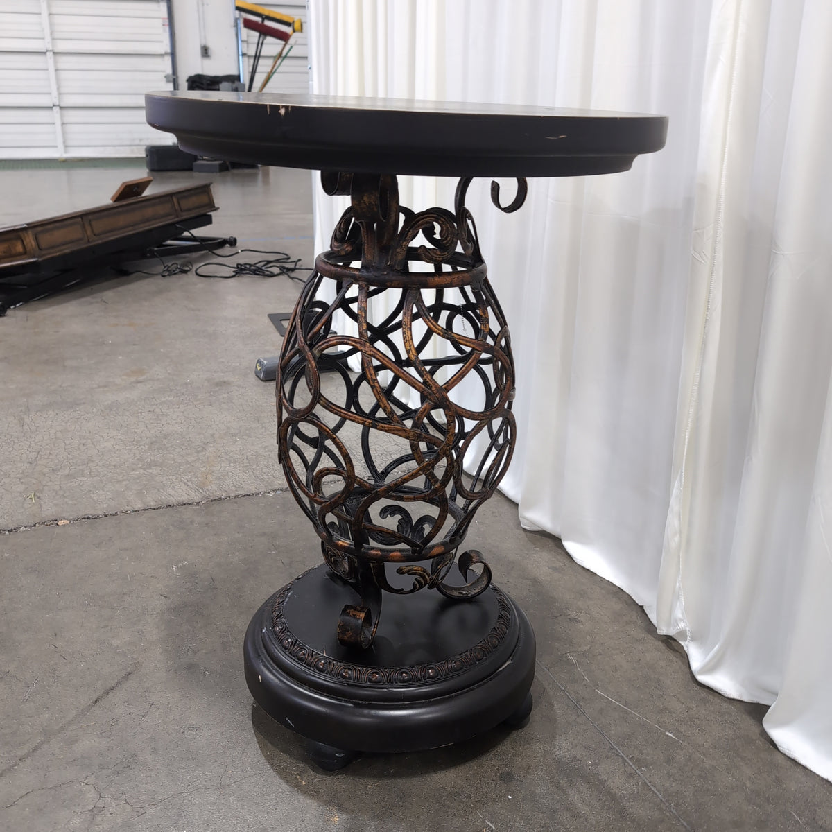 Round Dark Wood End Table with Ornate Metal Base
