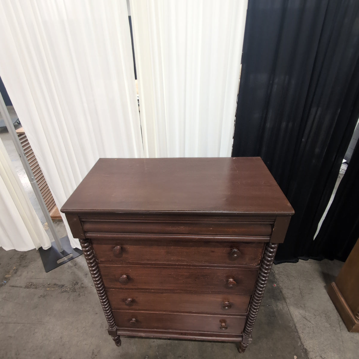 Dark Wood Four-Drawer Dresser with Turned Columns
