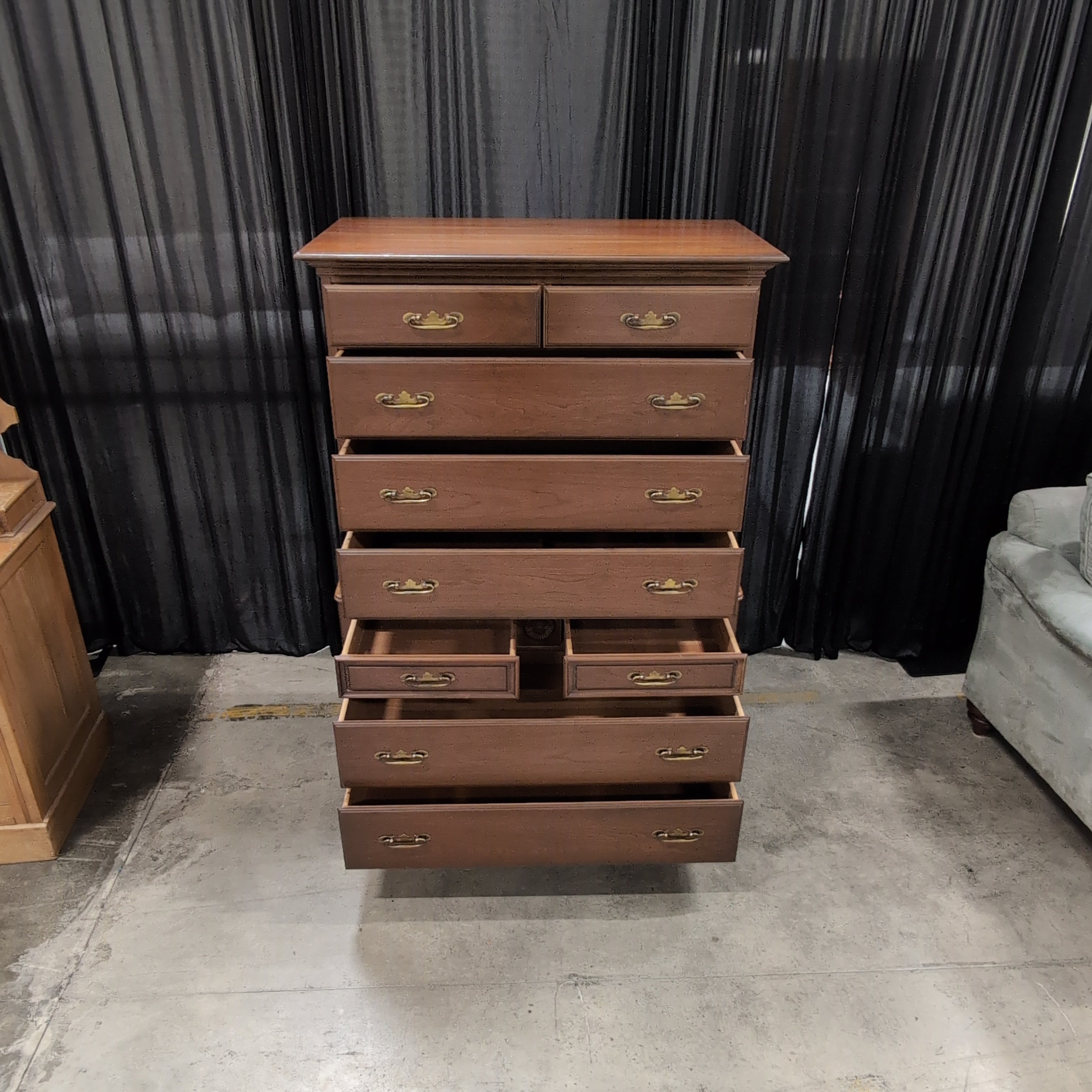 Traditional Cherry Stained Wood Tall Dresser with Ornate Hardware