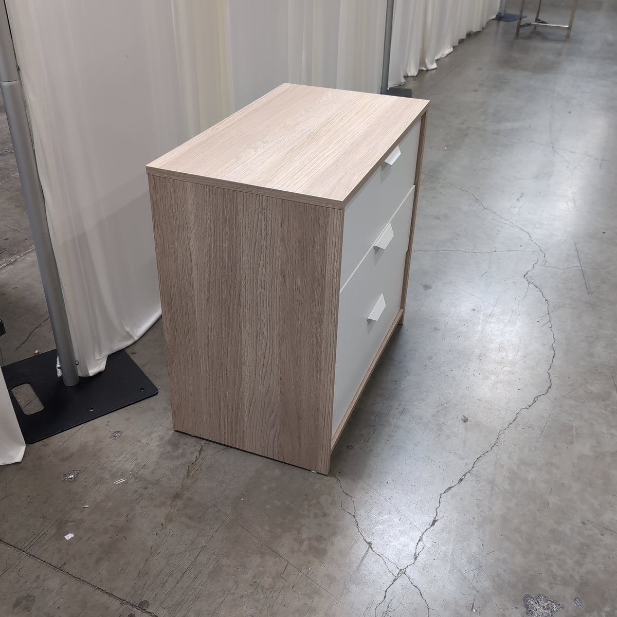 Light Wood Three-Drawer Nightstand with Recessed Pulls
