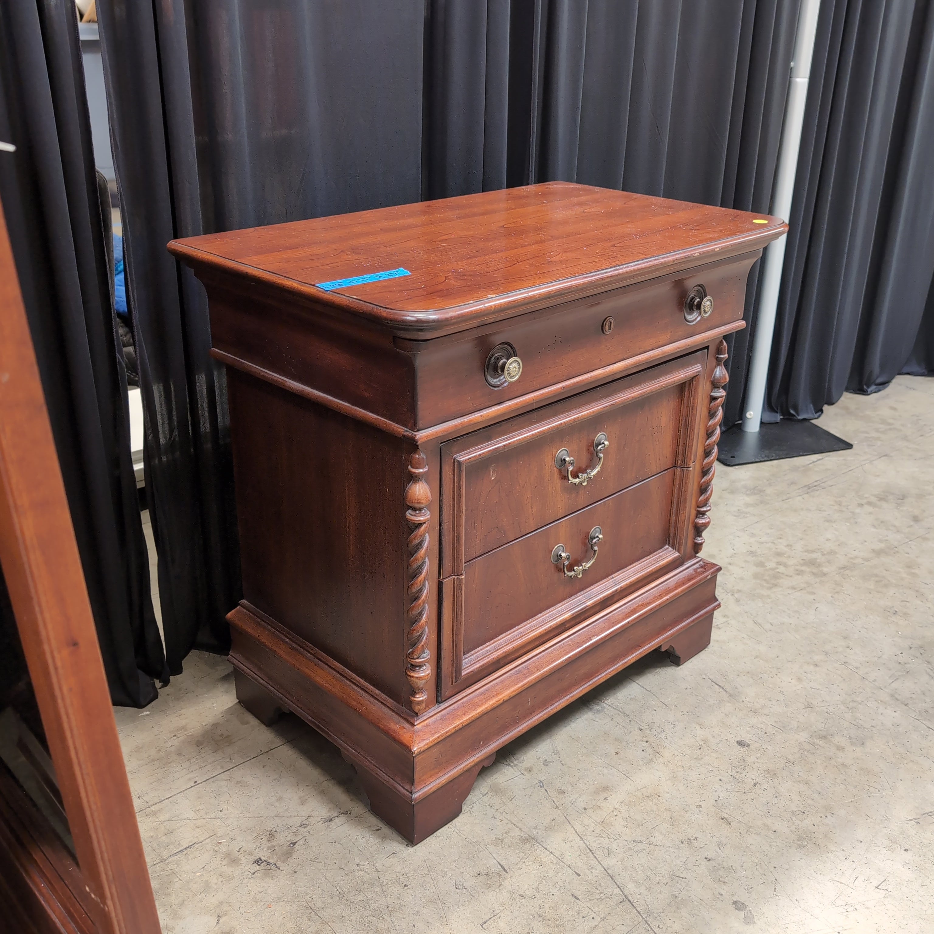 Cherry Finish Wood Nightstand with Ornate Hardware
