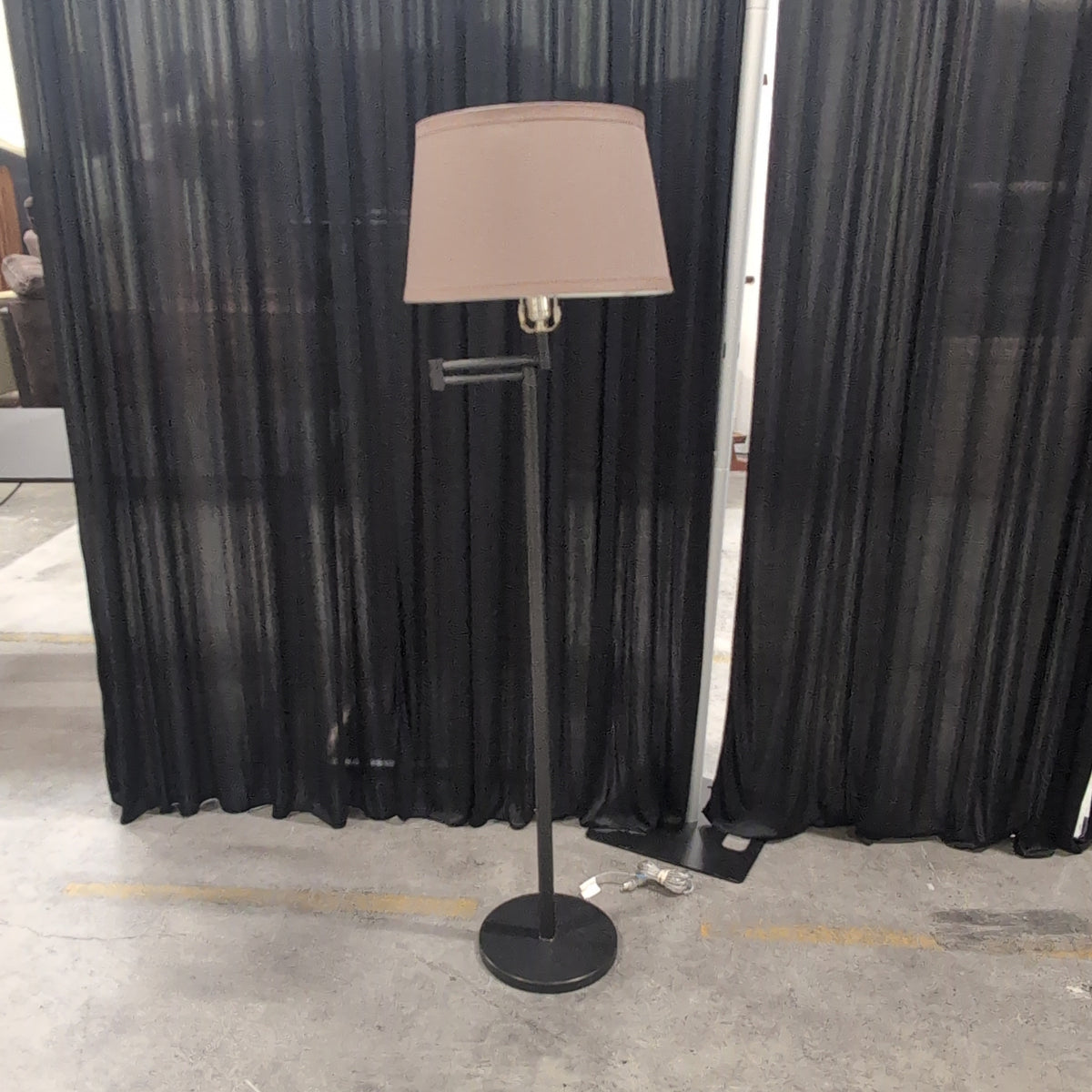 Black Metal Swing Arm Floor Lamp with Tan Shade