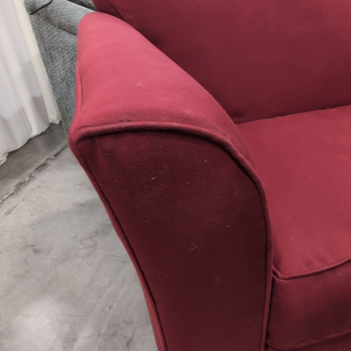 Red Fabric Upholstered Two-Cushion Couch