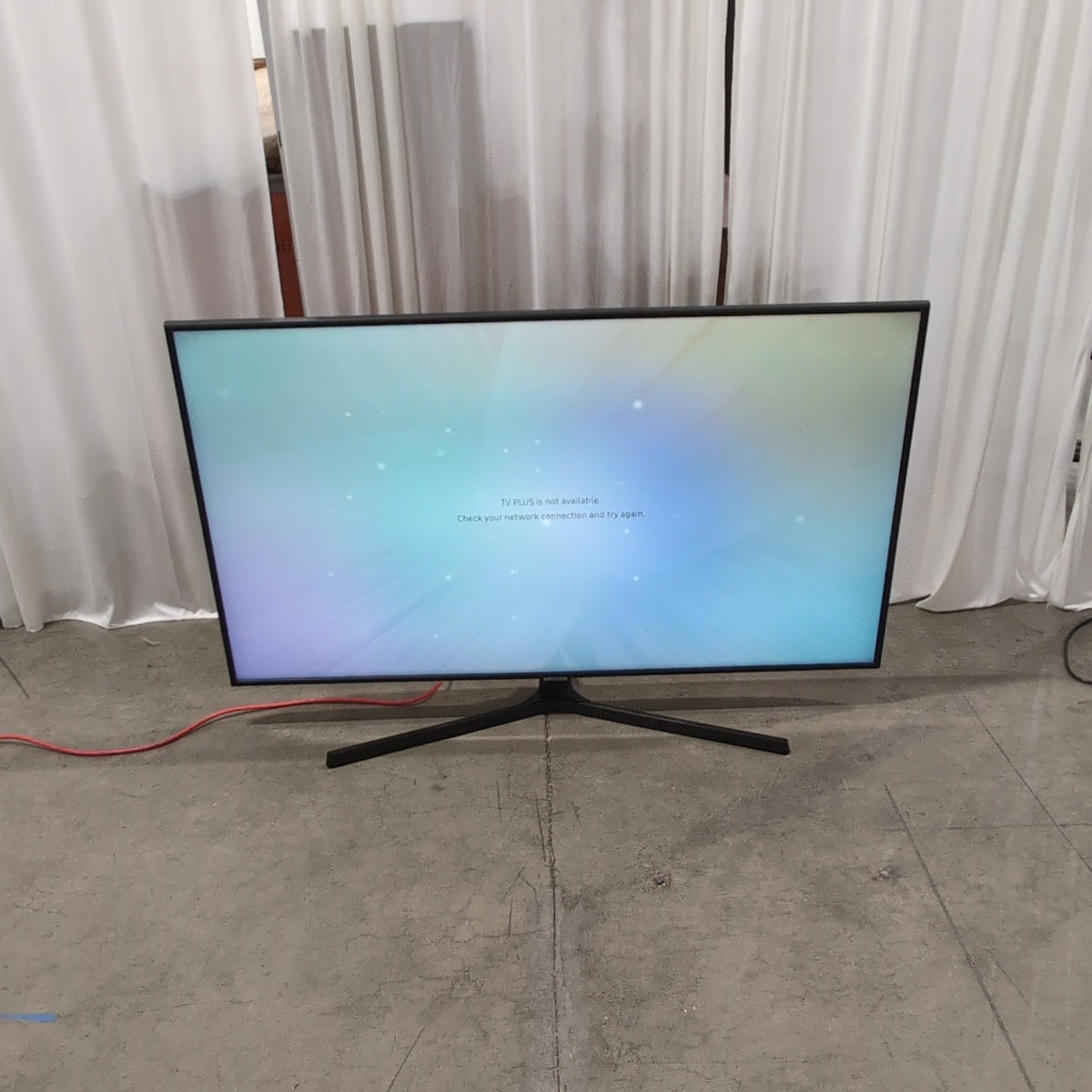 Samsung-Black Flat Screen Television with Stand