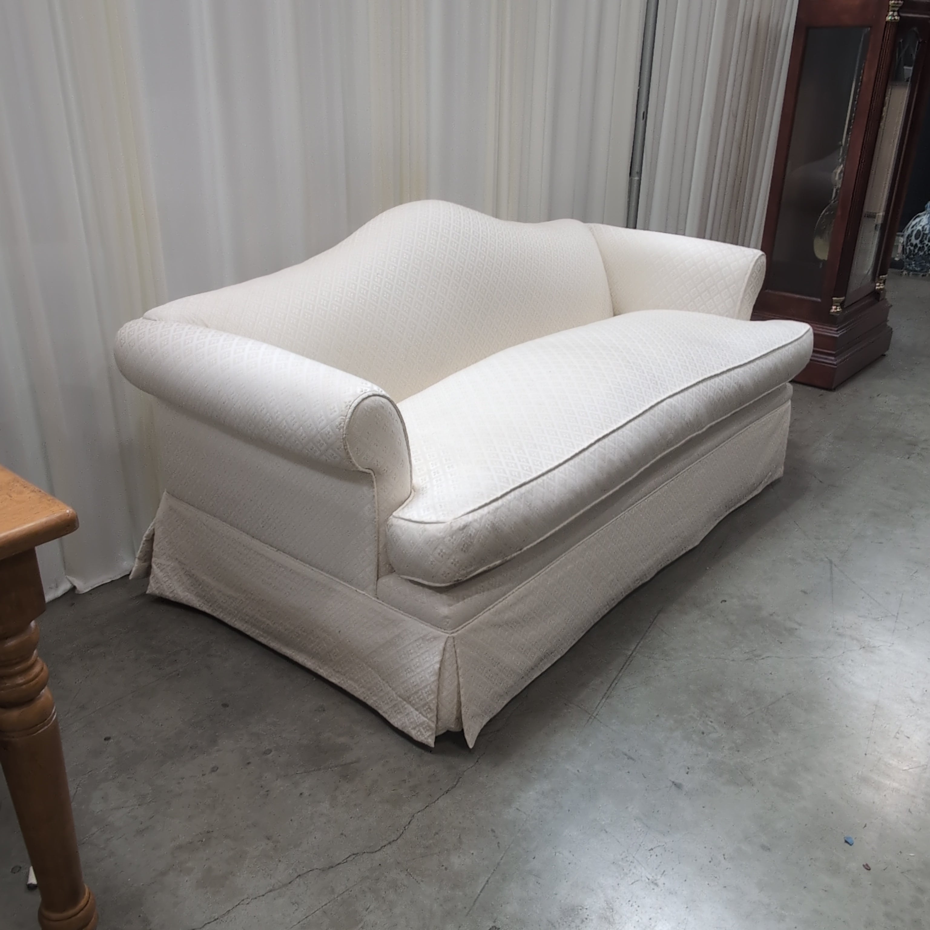 Cream Patterned Fabric Loveseat with Rolled Arms