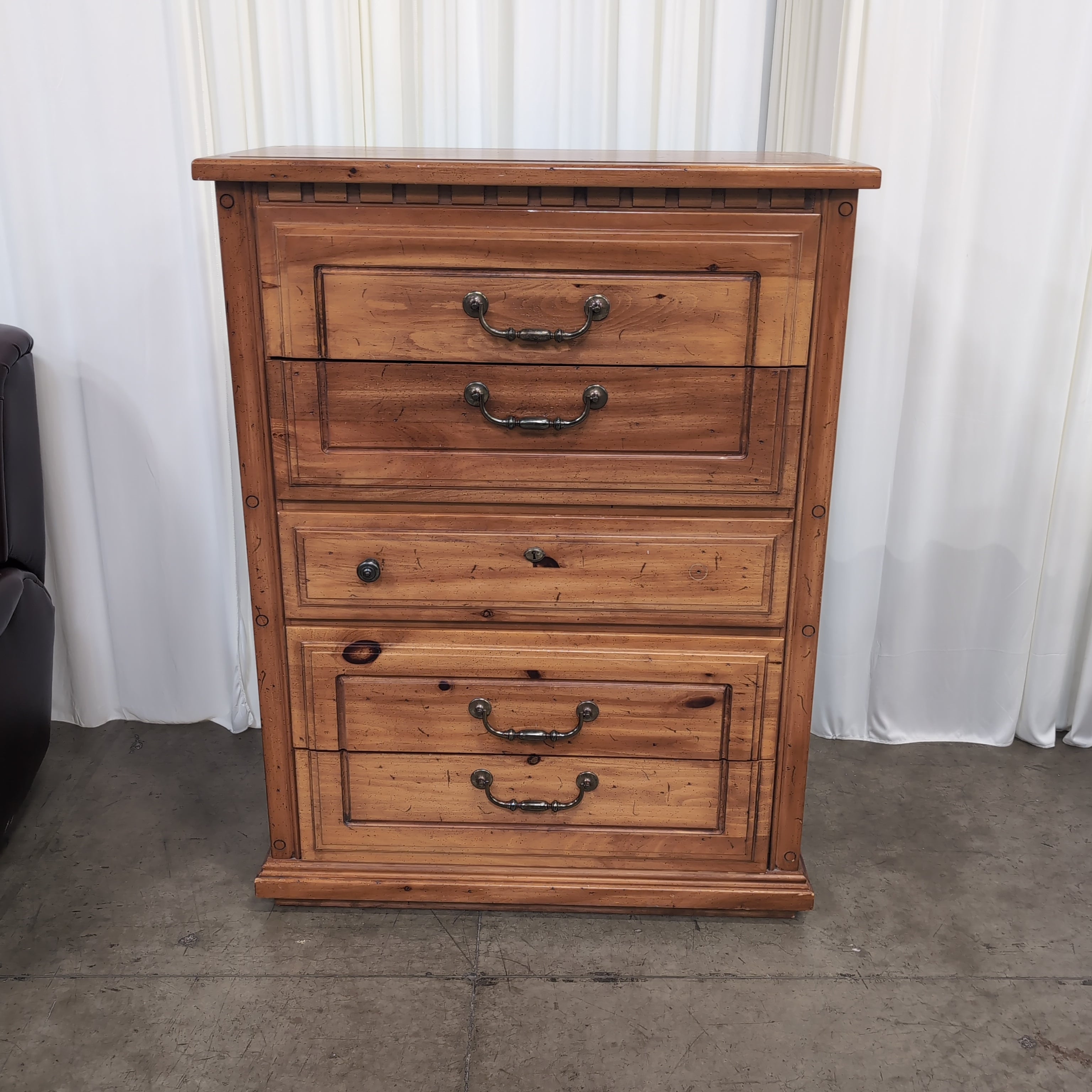 Honey-Toned Wood Four-Drawer Dresser with Decorative Molding