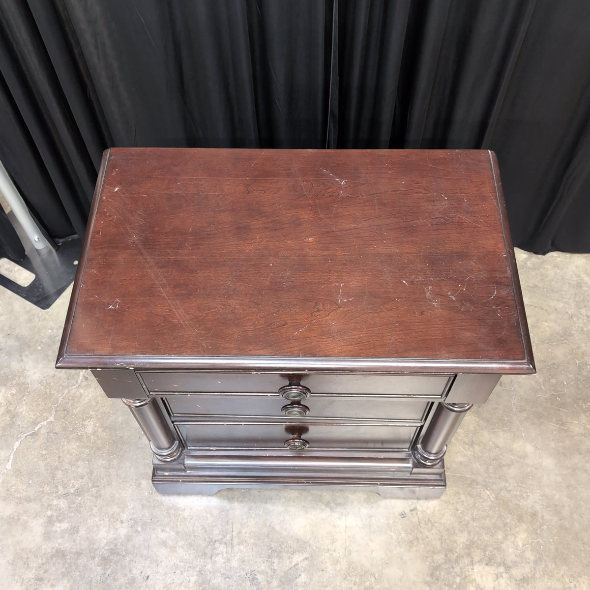 Dark Hardwood Three-Drawer Nightstand with Turned Columns
