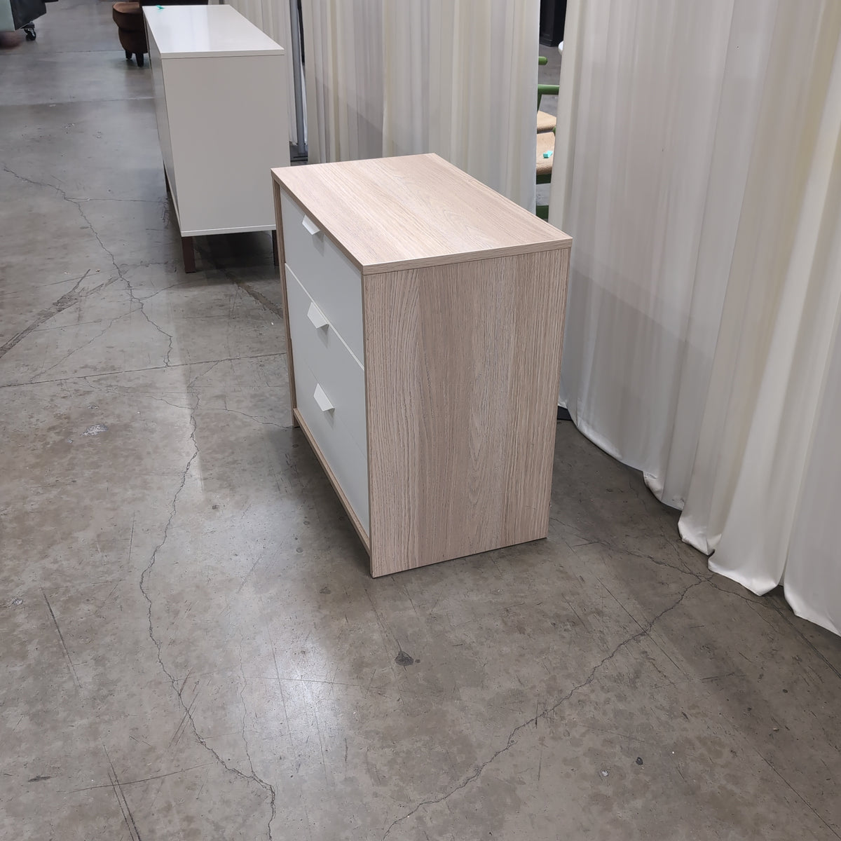 Light Wood Three-Drawer Nightstand with Recessed Pulls