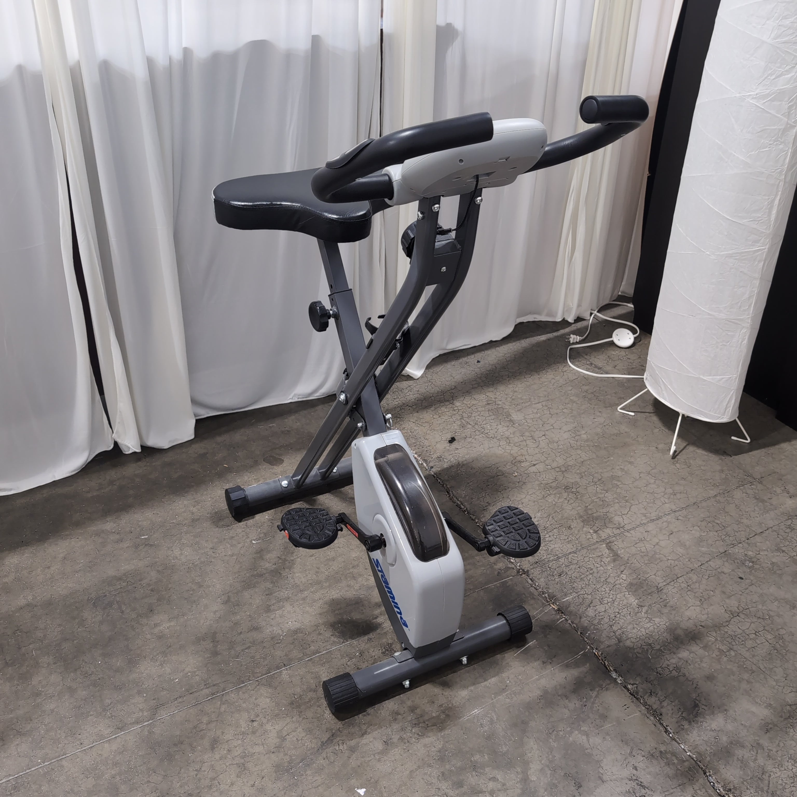 Compact Black Stationary Exercise Bike with Adjustable Seat