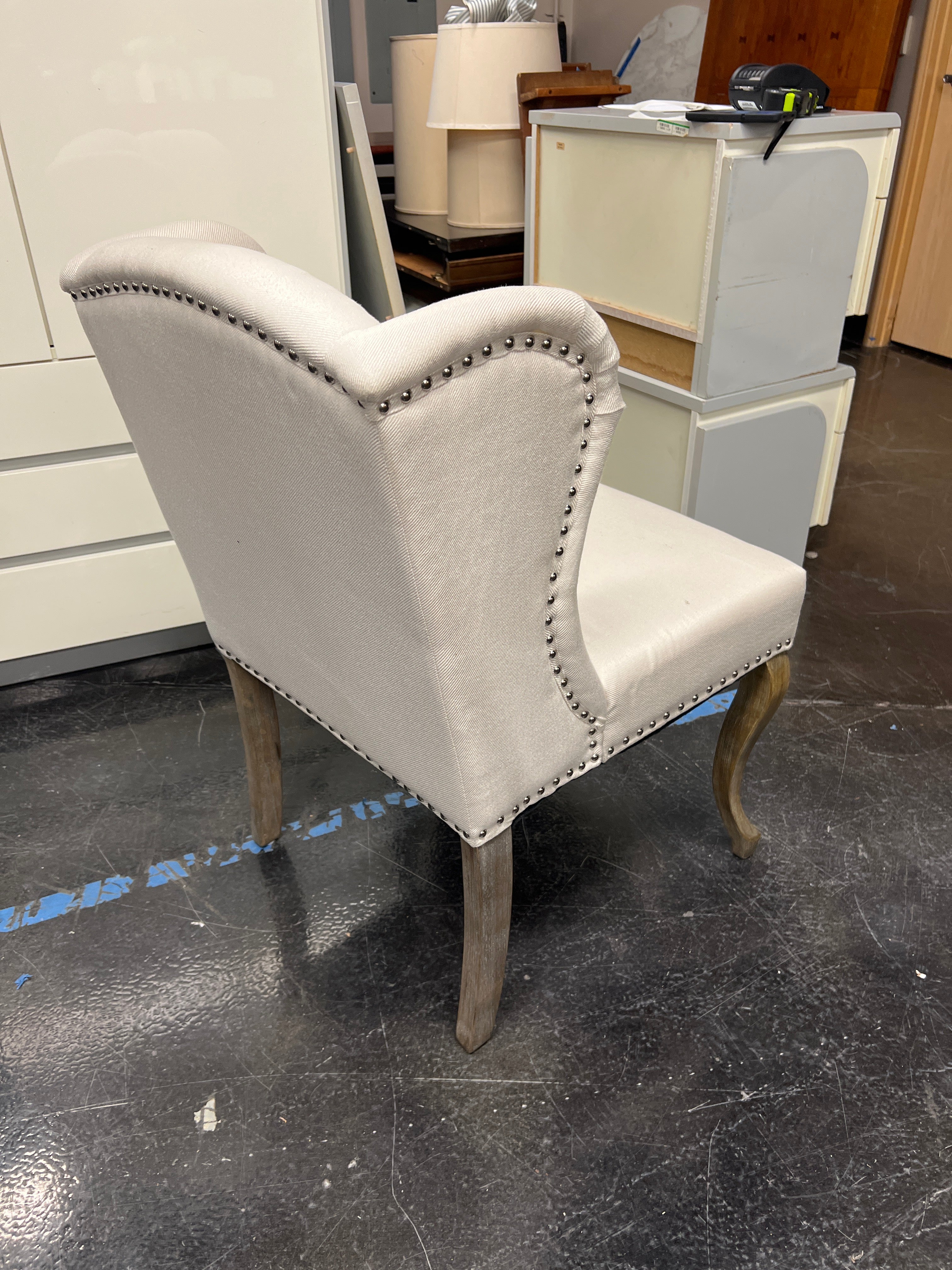 Cream-Colored Wingback Chair with Button Tufting