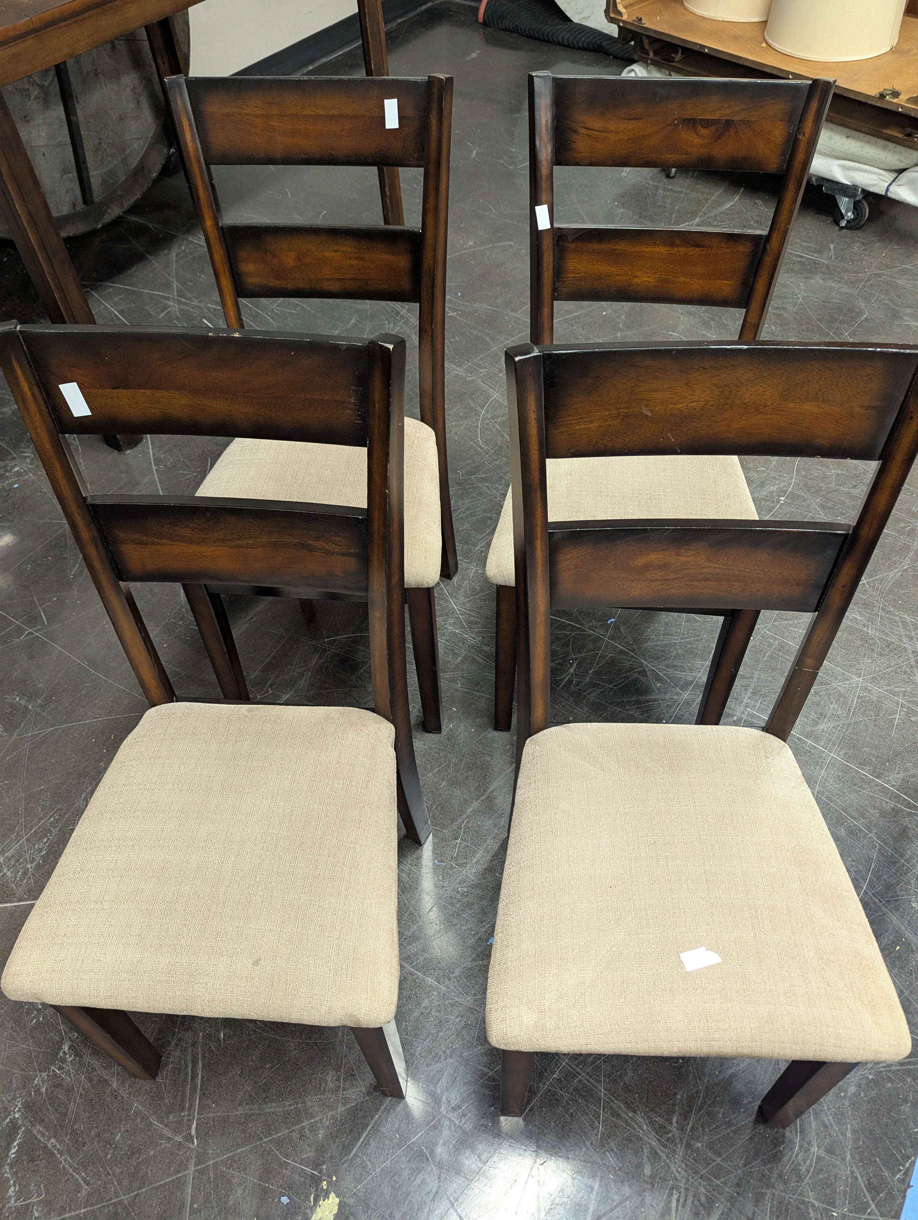 Set of Four Brown Wood Dining Chairs with Beige Cushions
