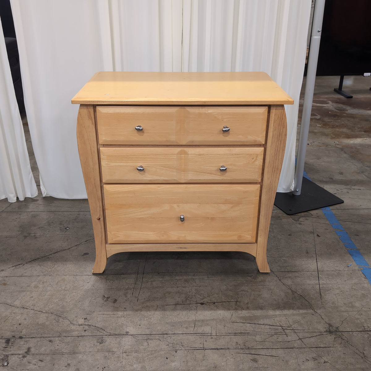 Light Wood Three-Drawer Nightstand with Curved Sides