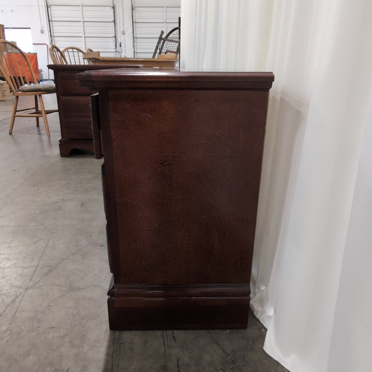 Dark Wood Three-Drawer Nightstand with Ornate Hardware