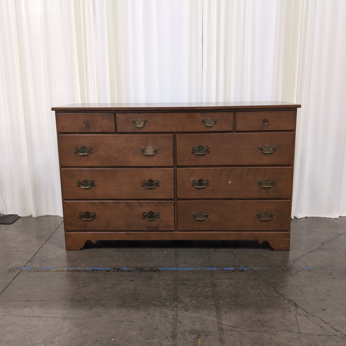 Brown Wood Nine-Drawer Dresser with Ornate Hardware