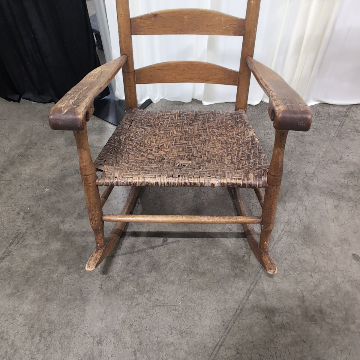 Brown Ladder-Back Rocking Chair with Woven Seat